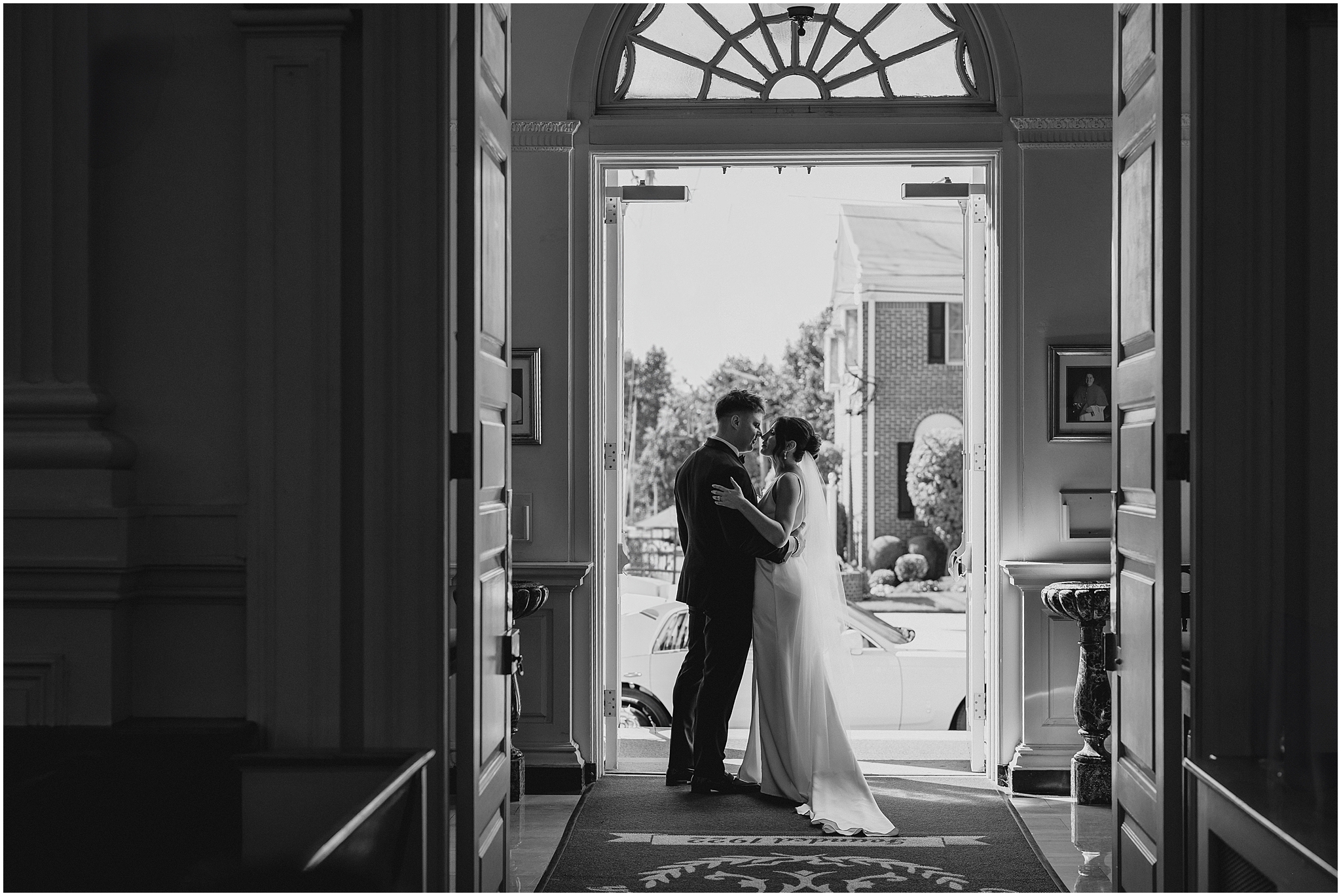bride and groom hug in doorway of NJ church looking at each other