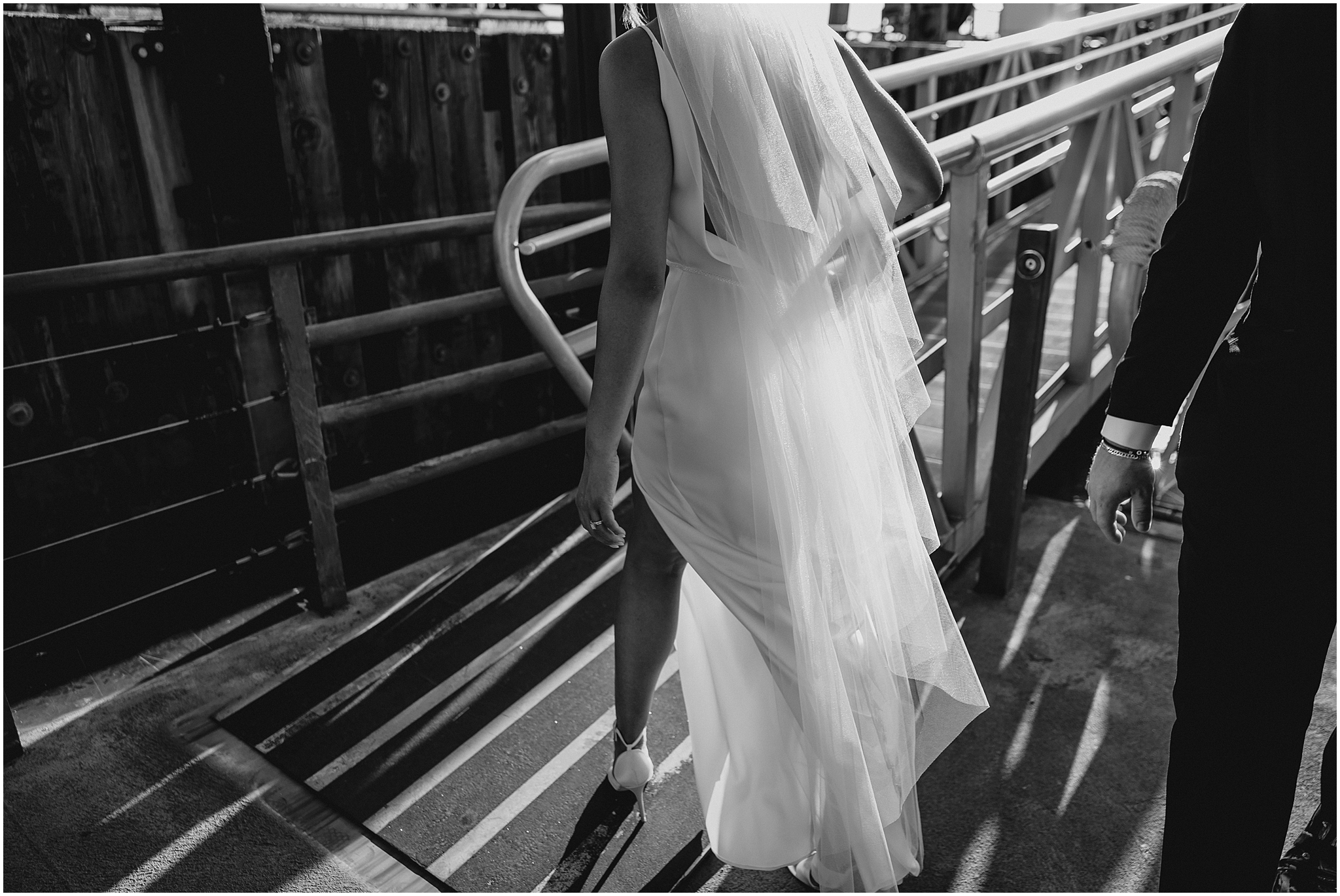 bride walks up plank to get on ship in New Jersey