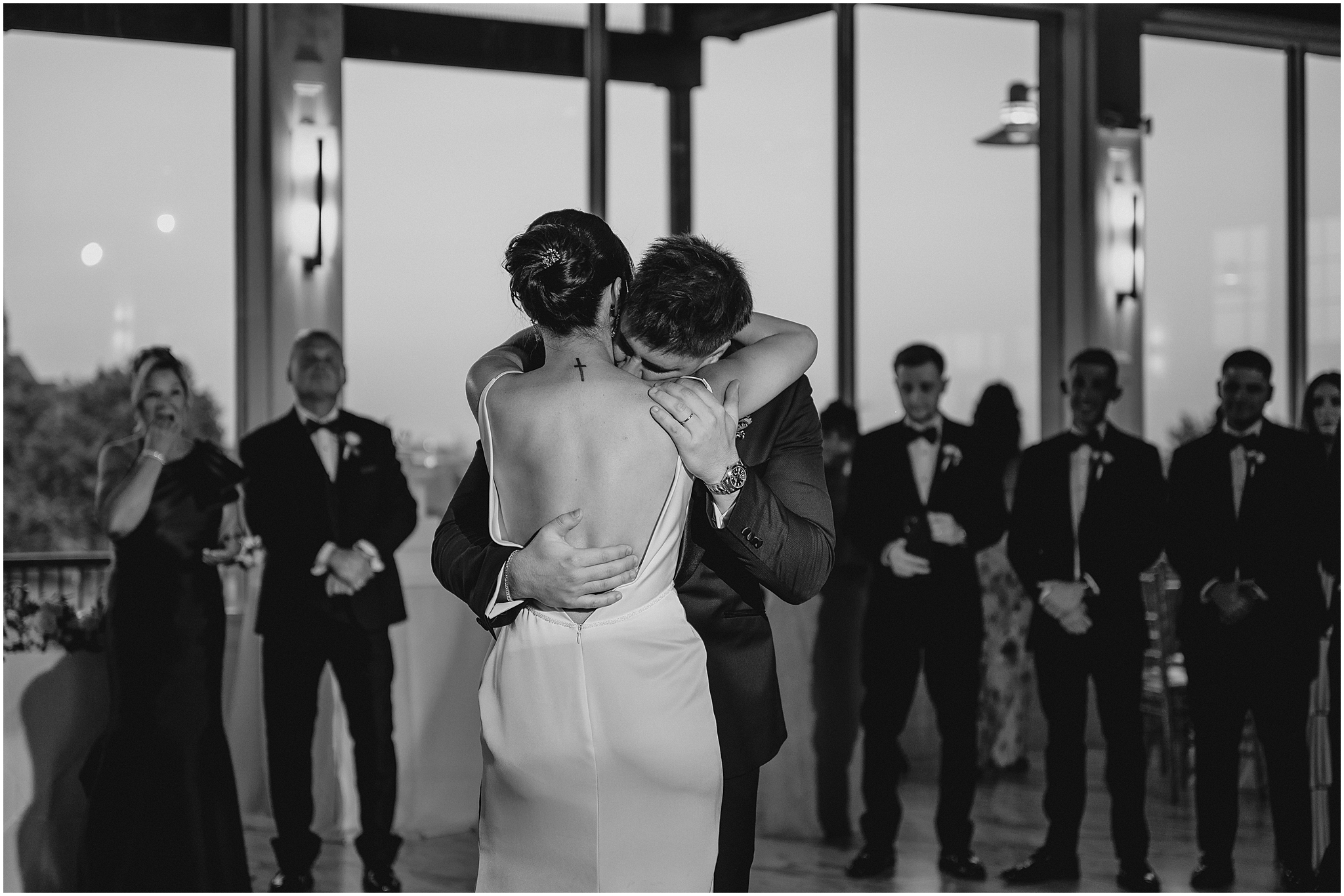 groom hugs bride kissing her neck on the dance floor at the Liberty House in Jersey City