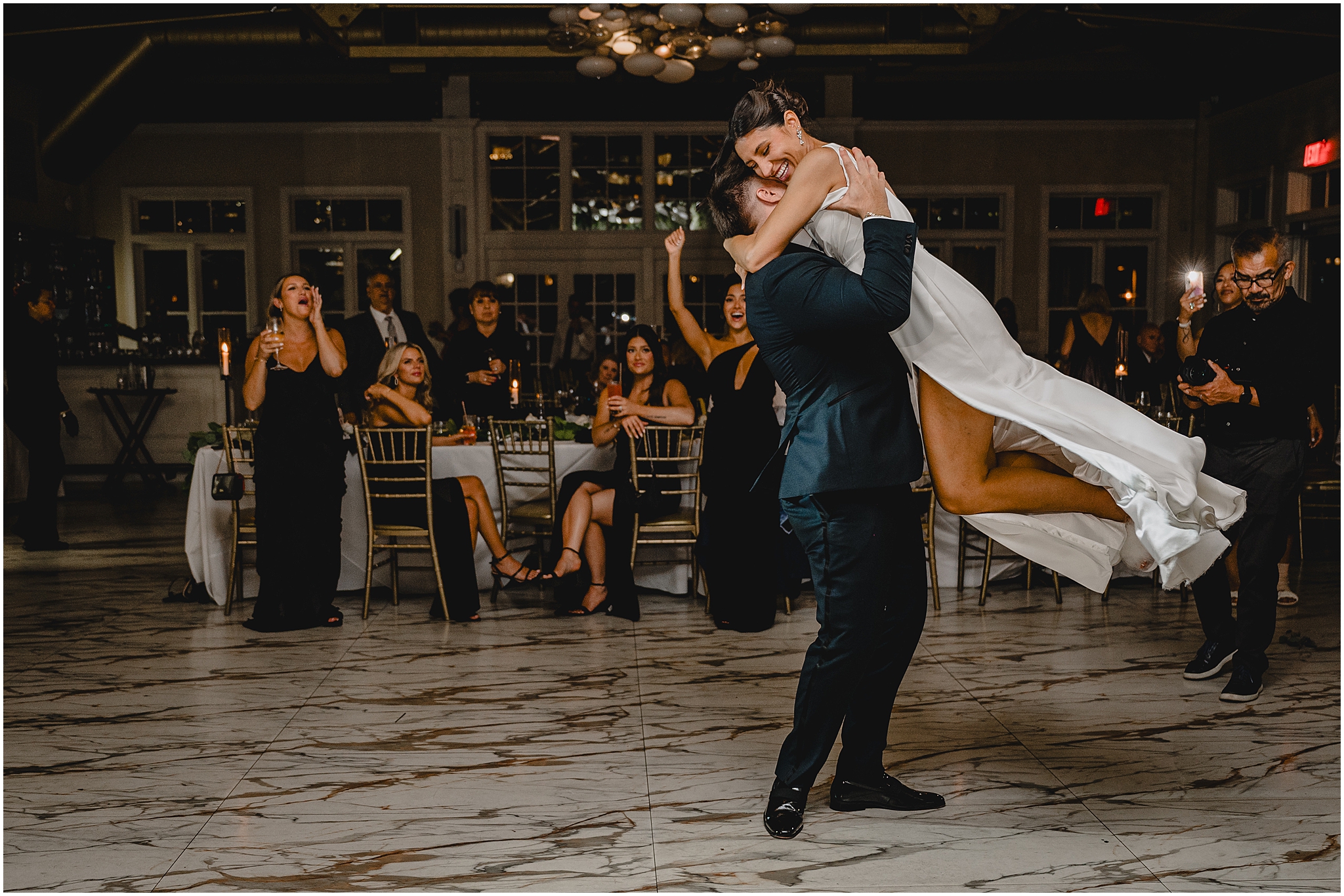 groom twirls around bride on dance floor during Liberty House wedding reception