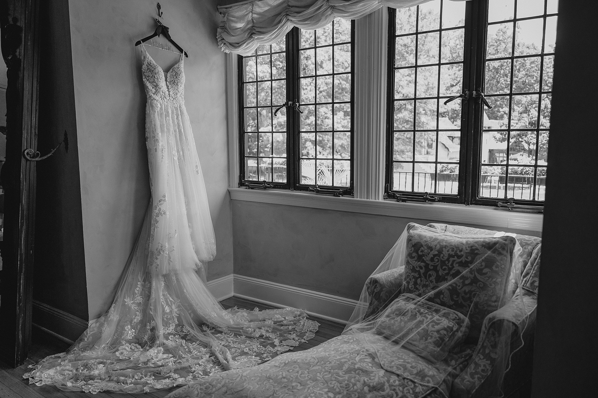 wedding dress hangs in bridal suite at Pleasantdale Chateau