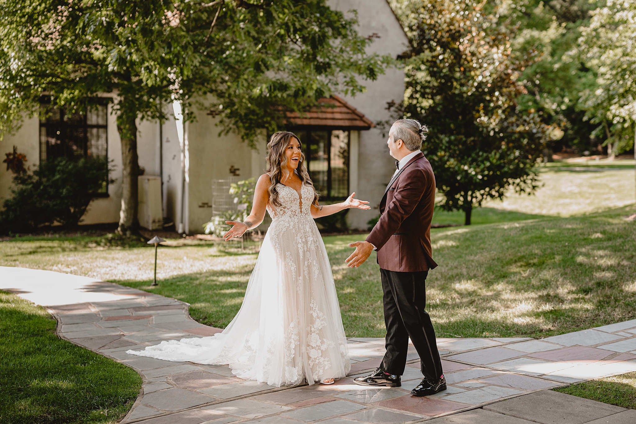 bride and groom have first look on brick pathway outside Pleasantdale Chateau