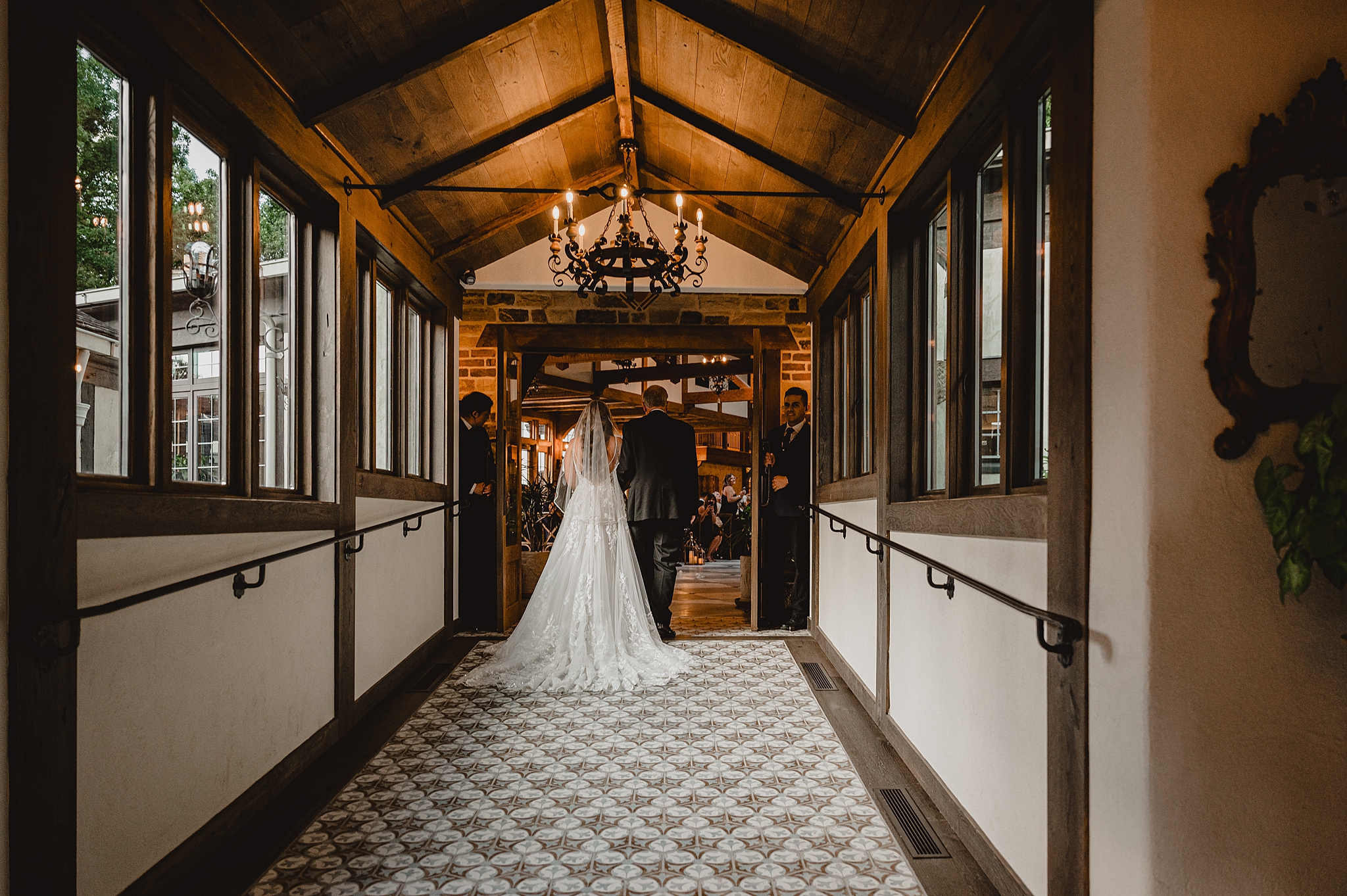bride and father walk together into ceremony at Pleasantdale Chateau
