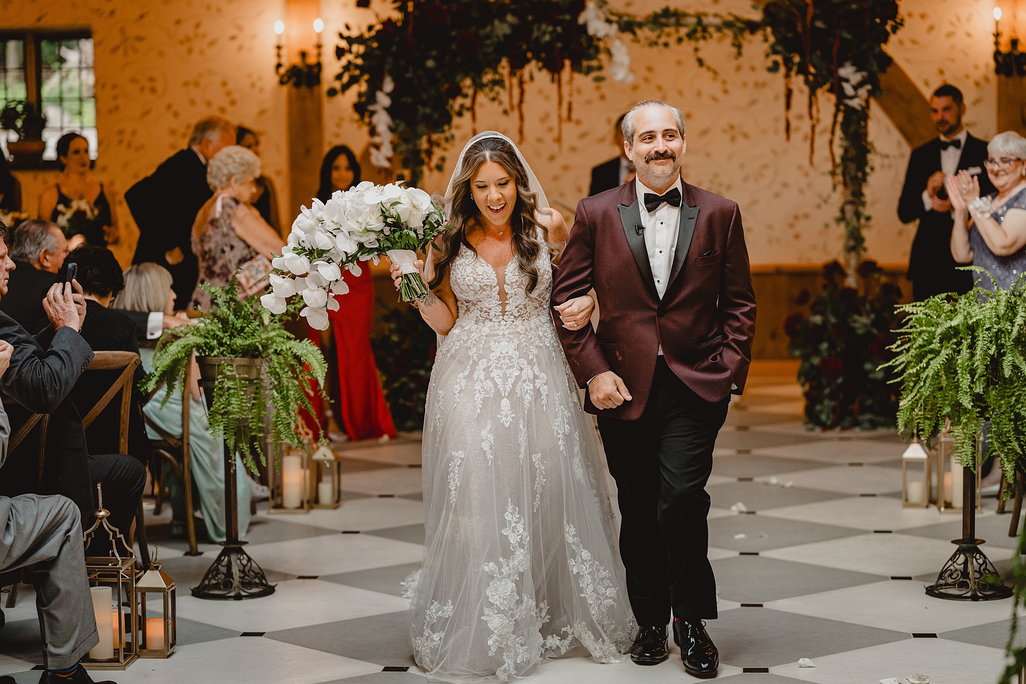 bride and groom walk up aisle after wedding ceremony at Pleasantdale Chateau