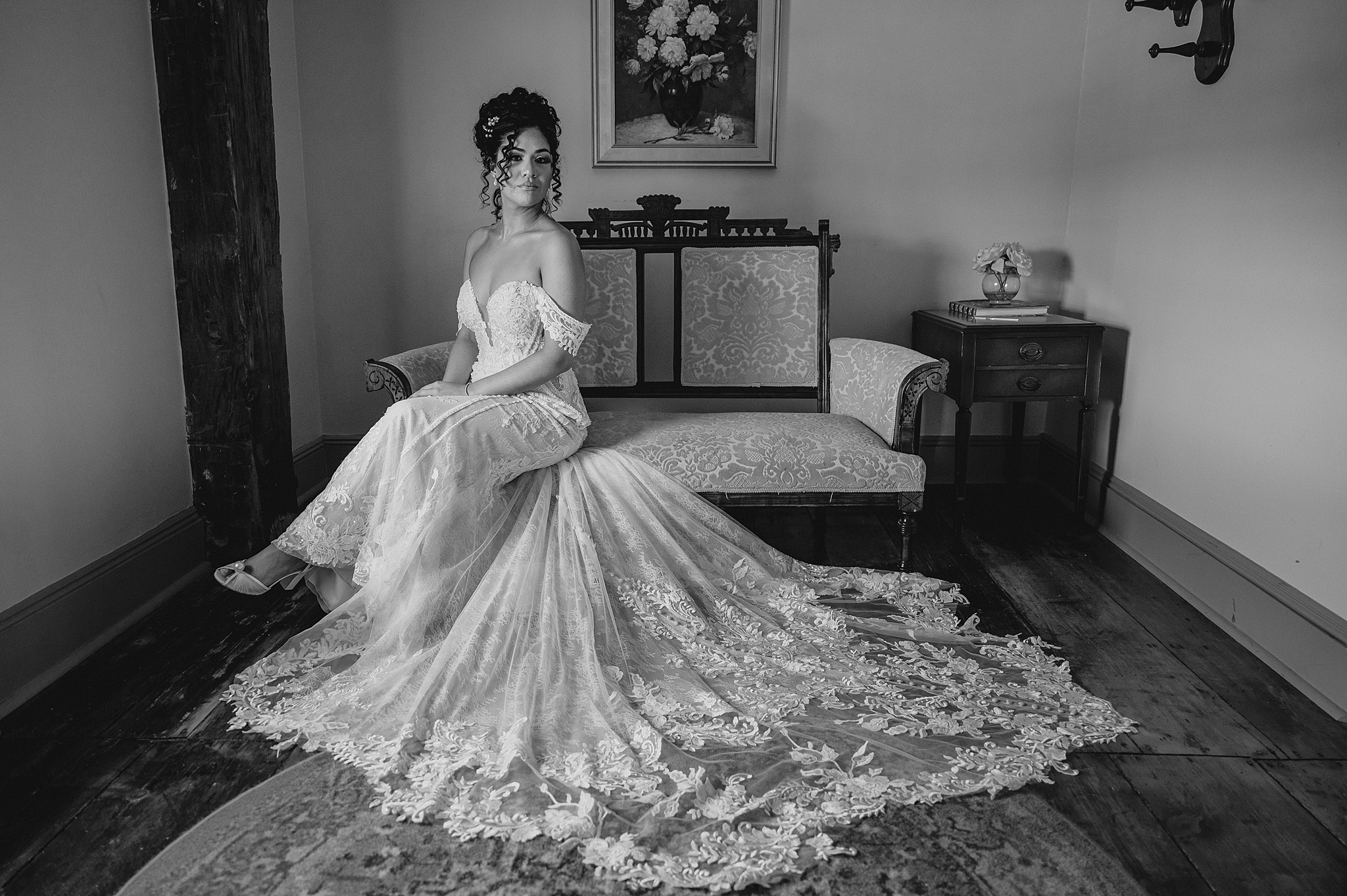 black and white bridal portrait sits on sofa inside suite at David's Country Inn