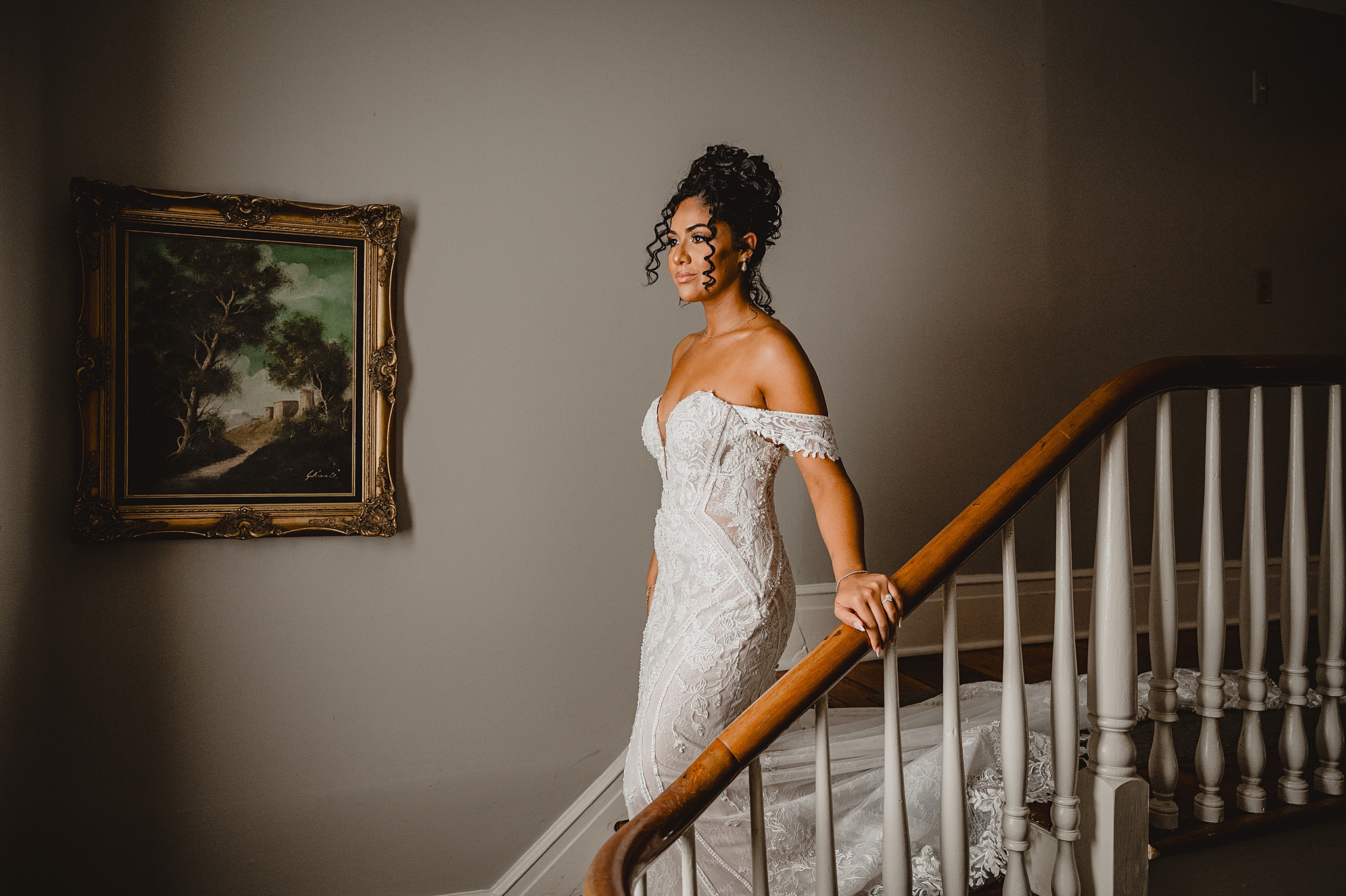 bride in strapless gown walks down staircase inside David's Country Inn