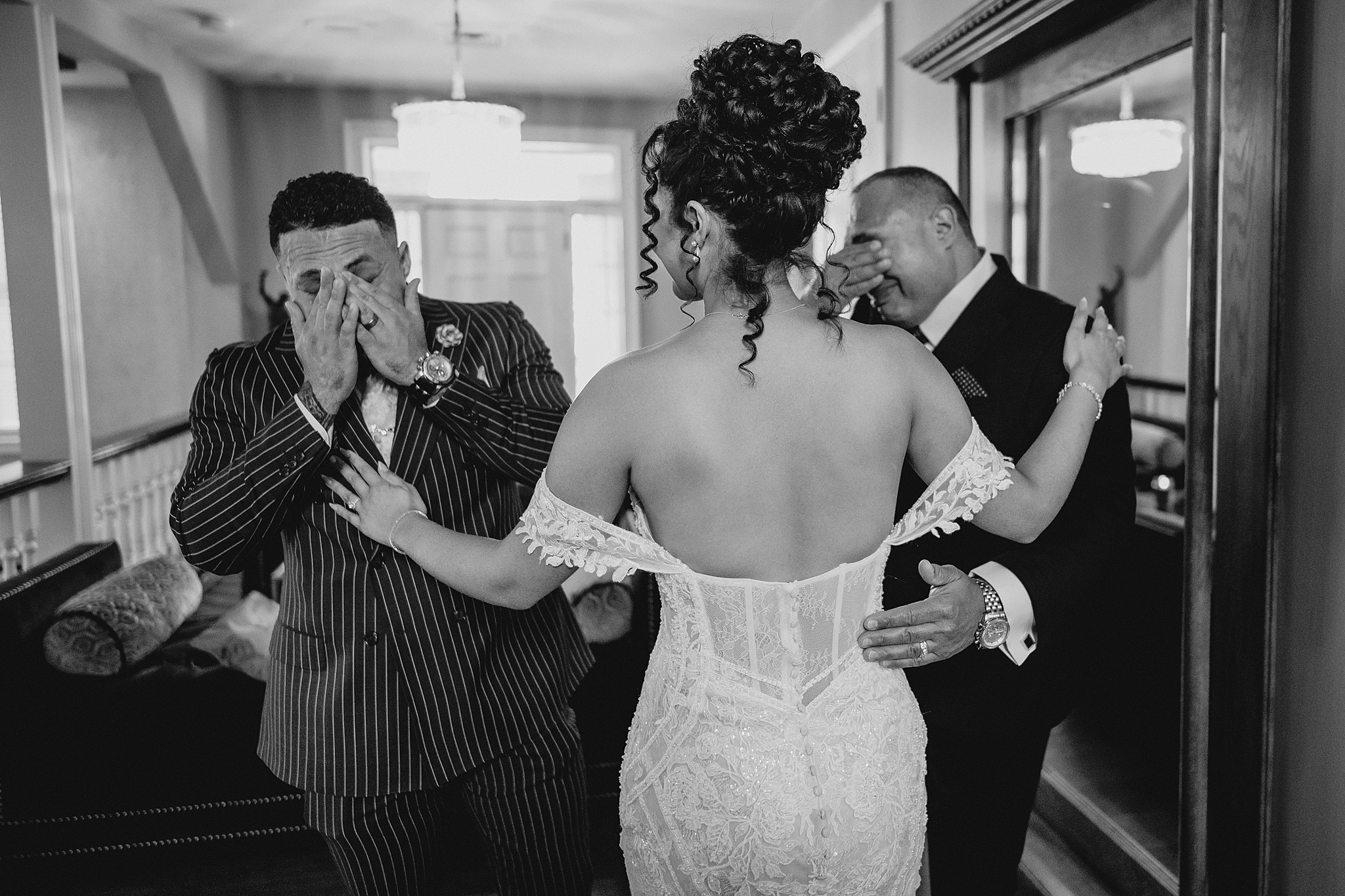 bride hugs brother and dad during first look on New Jersey wedding day