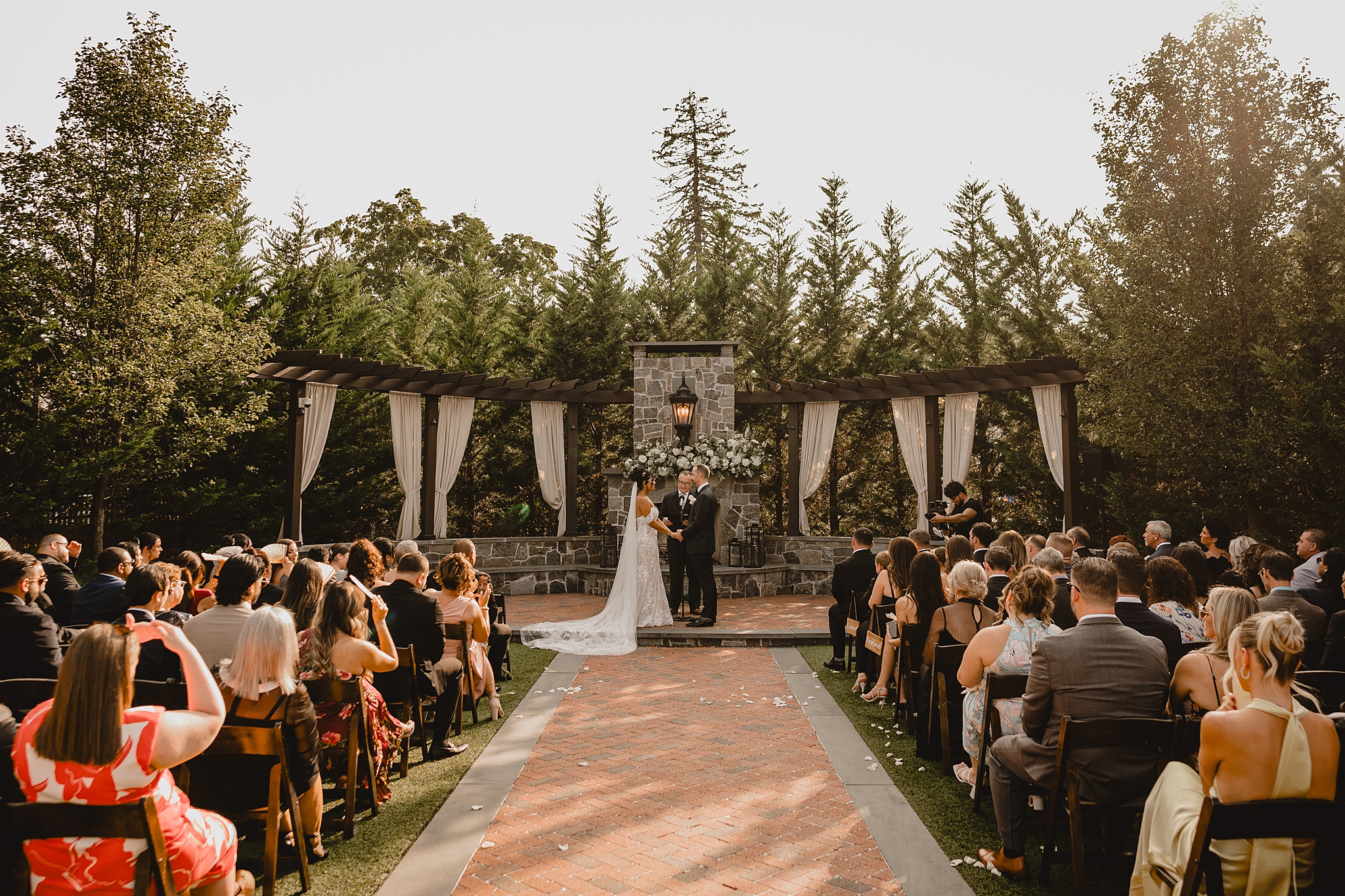 bride and groom hold hands on patio during wedding ceremony at David's Country Inn