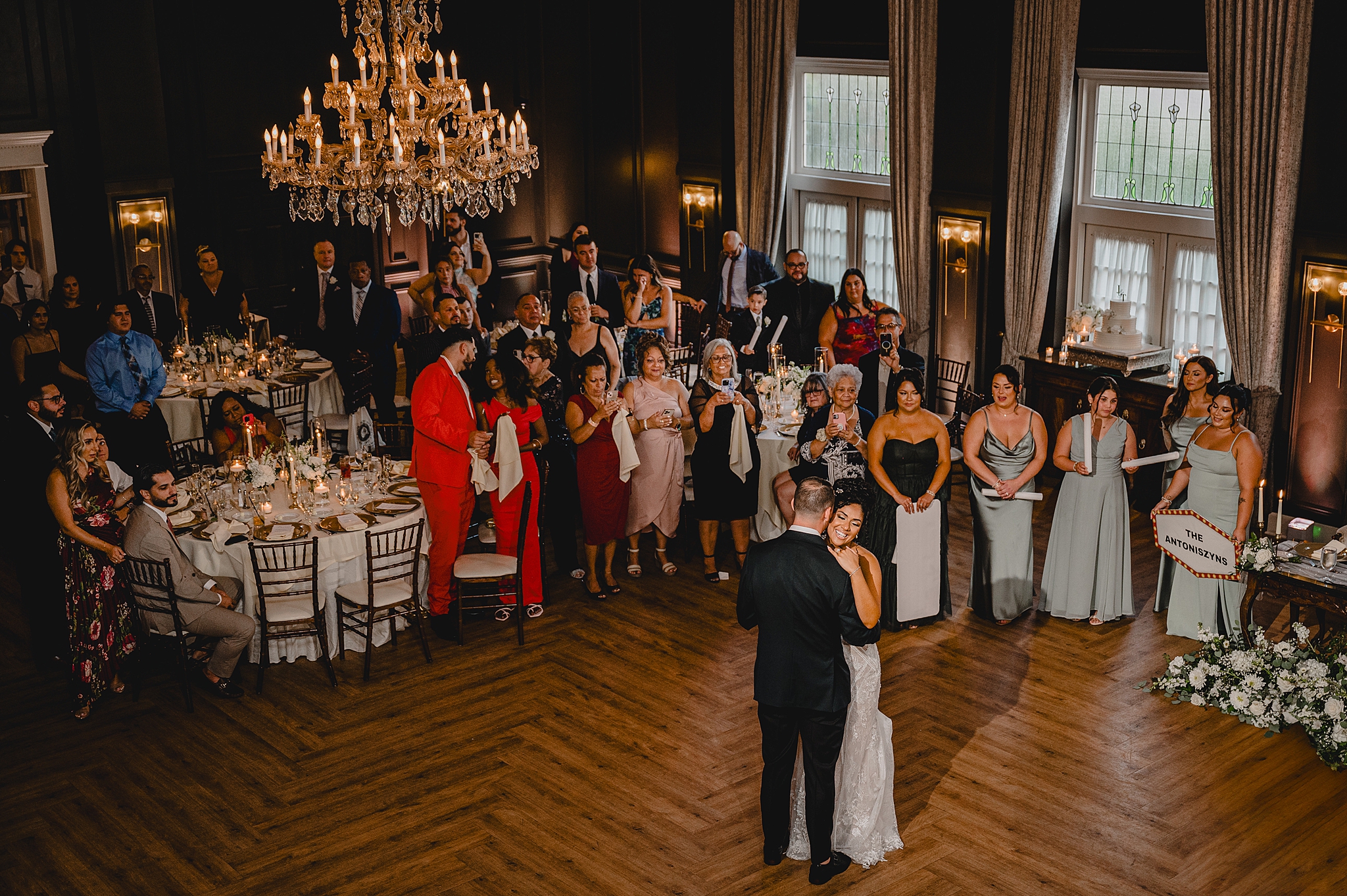 bride and groom hug close during first dance under chandelier in ballroom at David's Country InnDavid's Country InnDavid's Country Inn