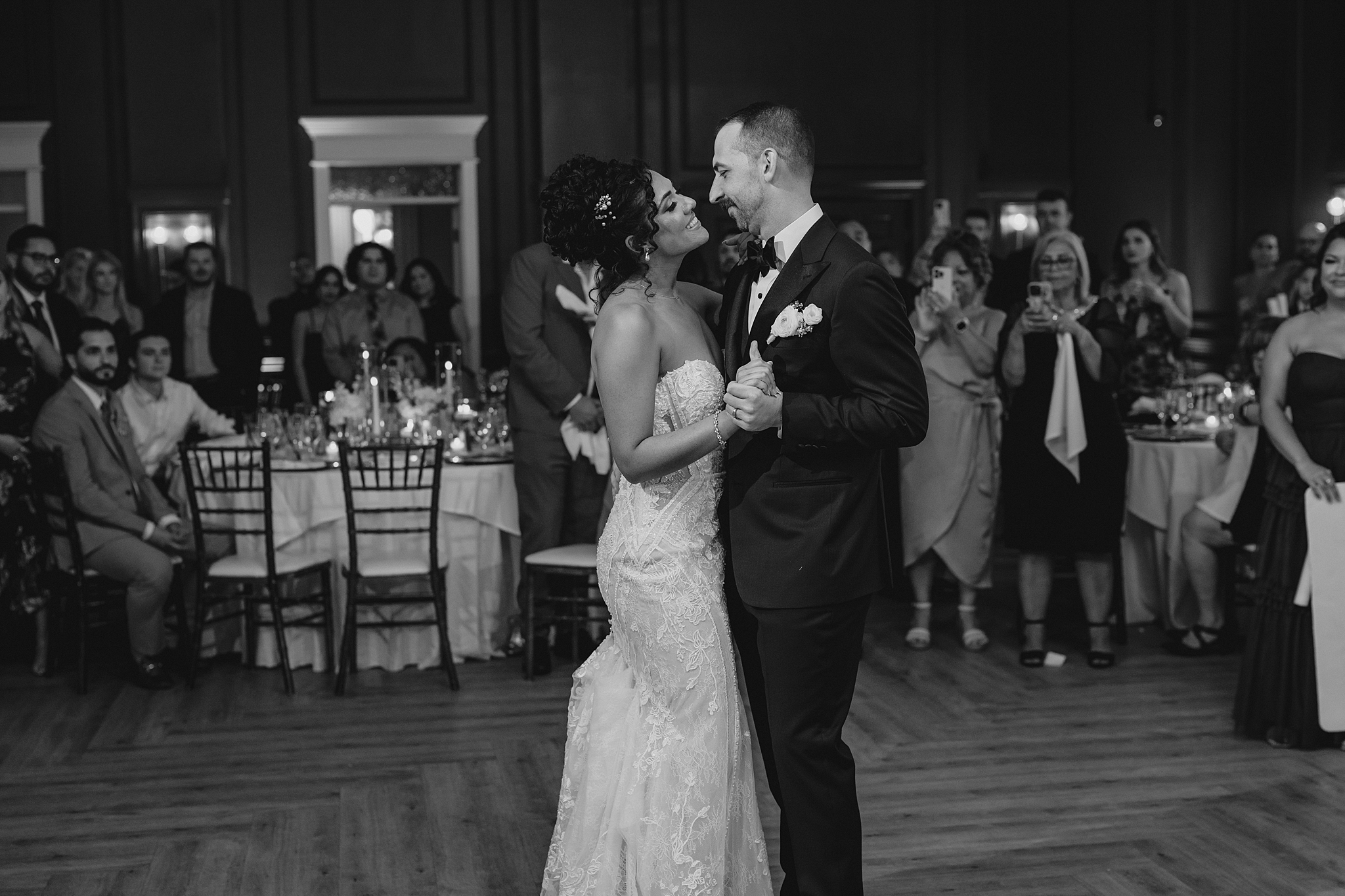 bride and groom smile together during first dance in ballroom at David's Country Inn