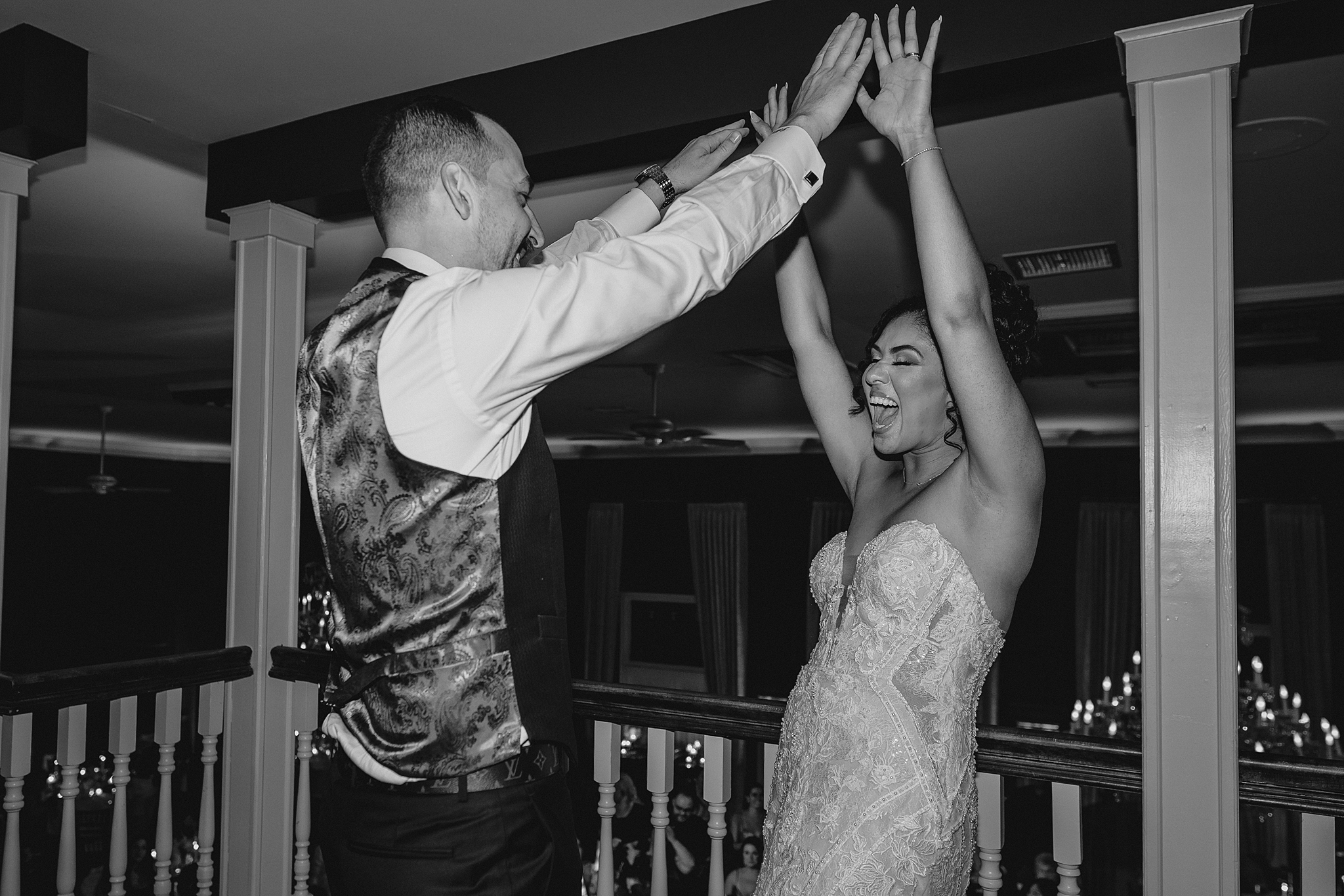 bride and groom cheer on balcony at David's Country Inn