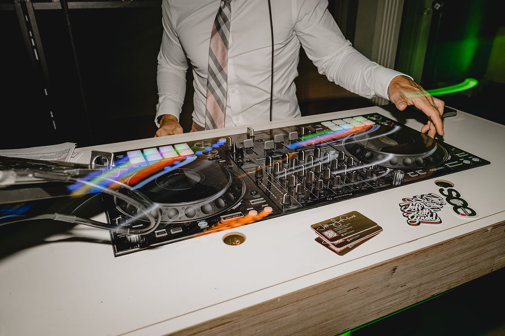 DJ plays with table setup during wedding reception 