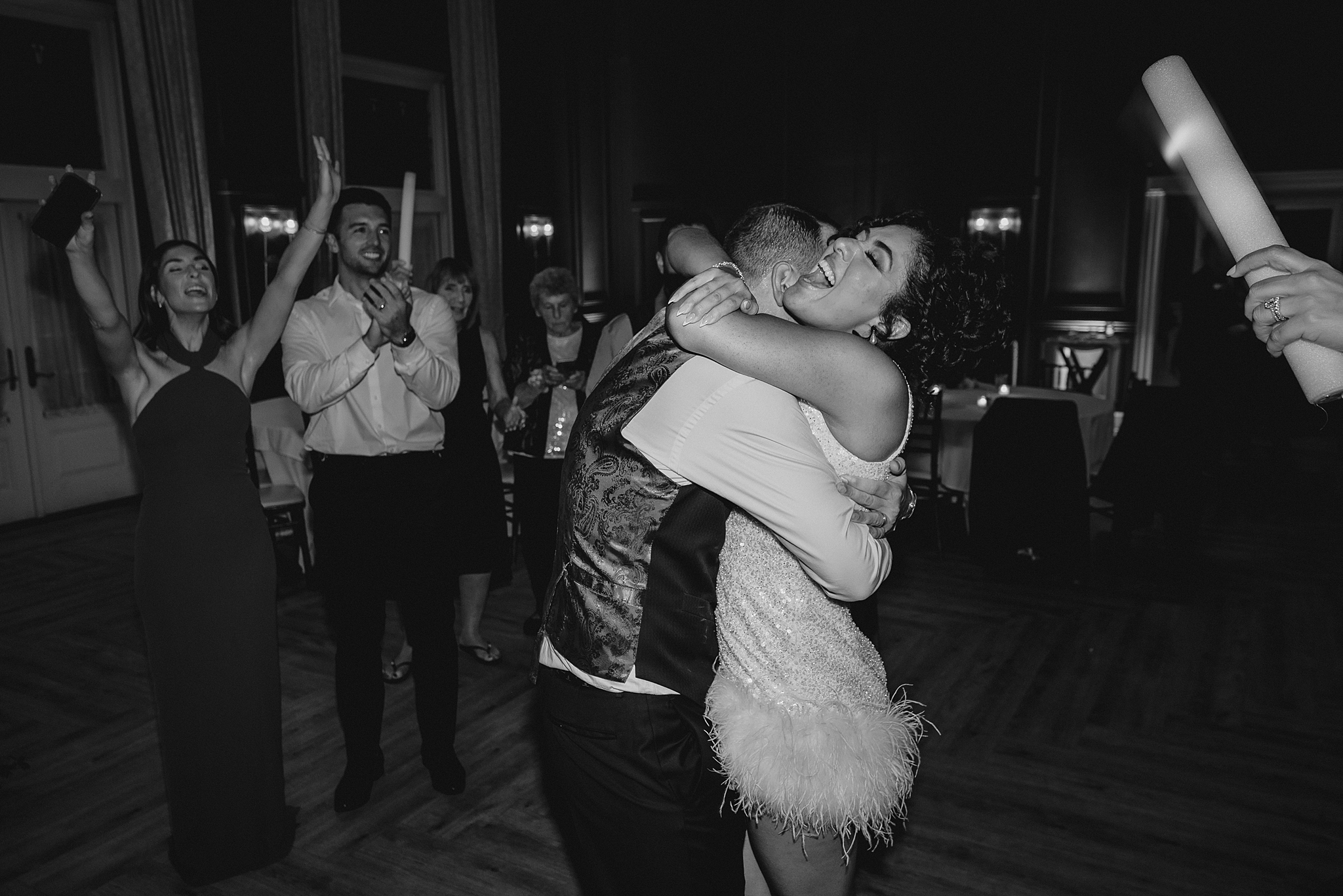 bride and groom hug on dance floor during wedding reception at David's Country Inn