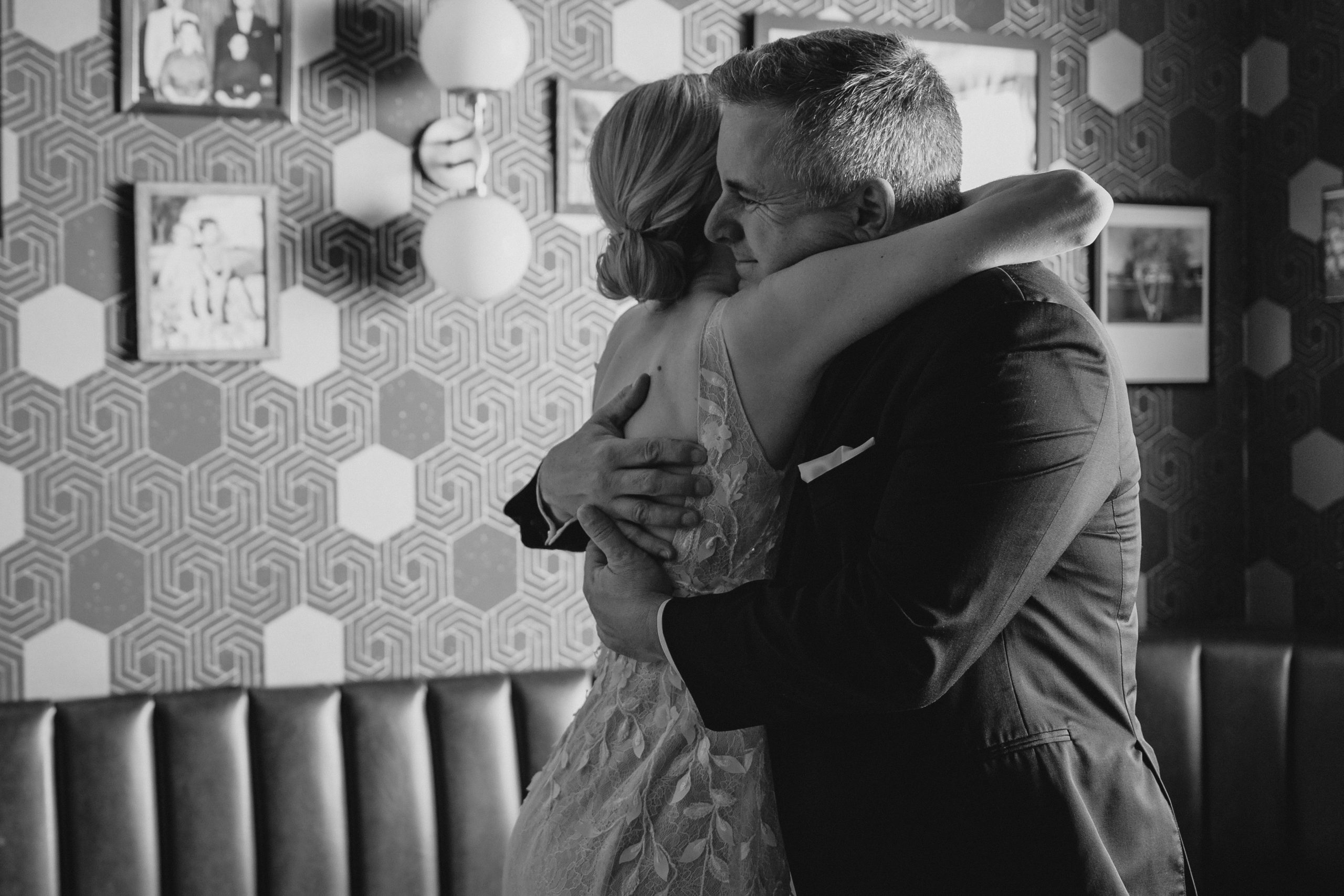 bride and dad hug during first look in suite at the Perona Farms Refinery