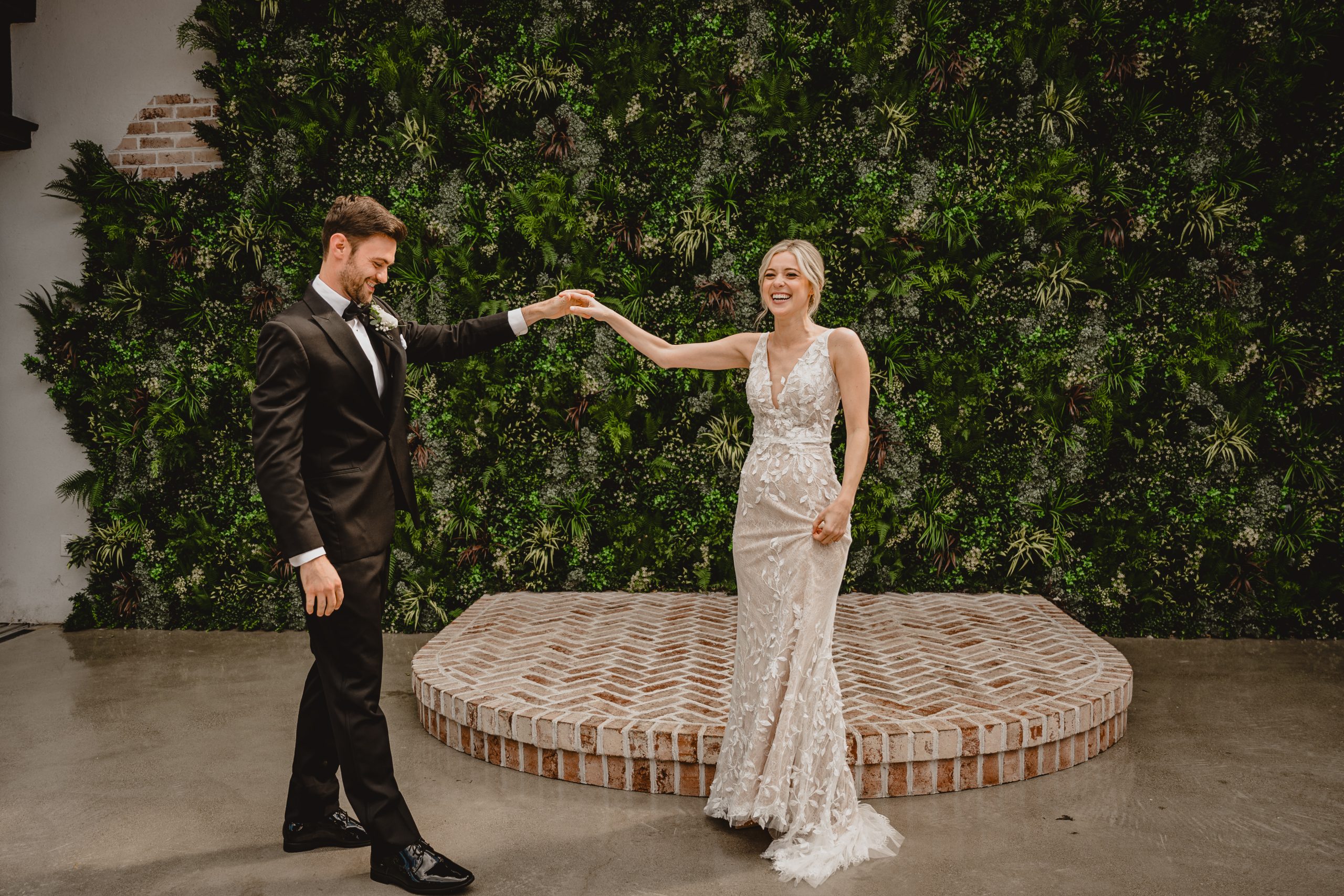 groom twirls bride during first look to see her wedding gown