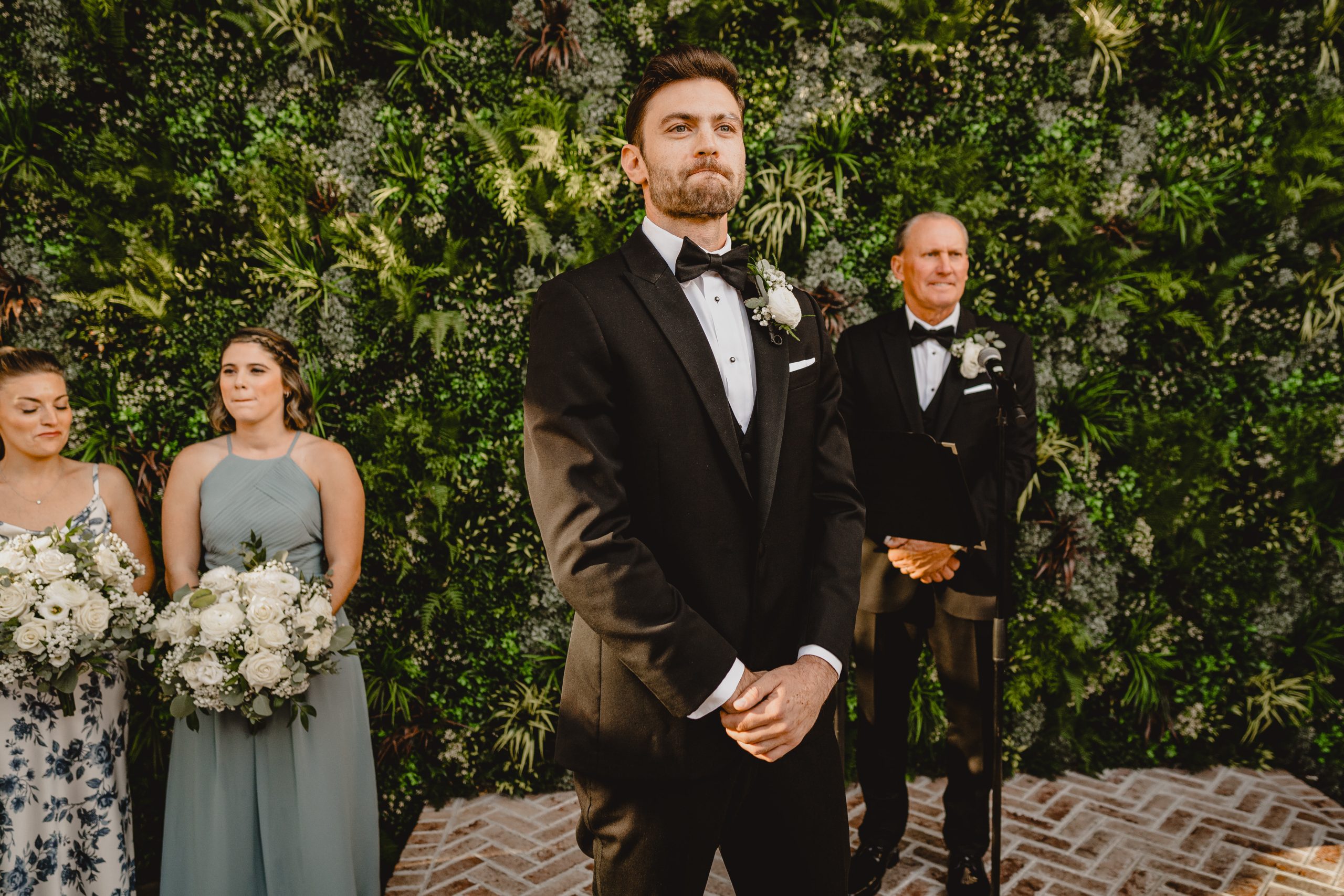 groom tears up during wedding ceremony in the courtyard at the Perona Farms Refinery