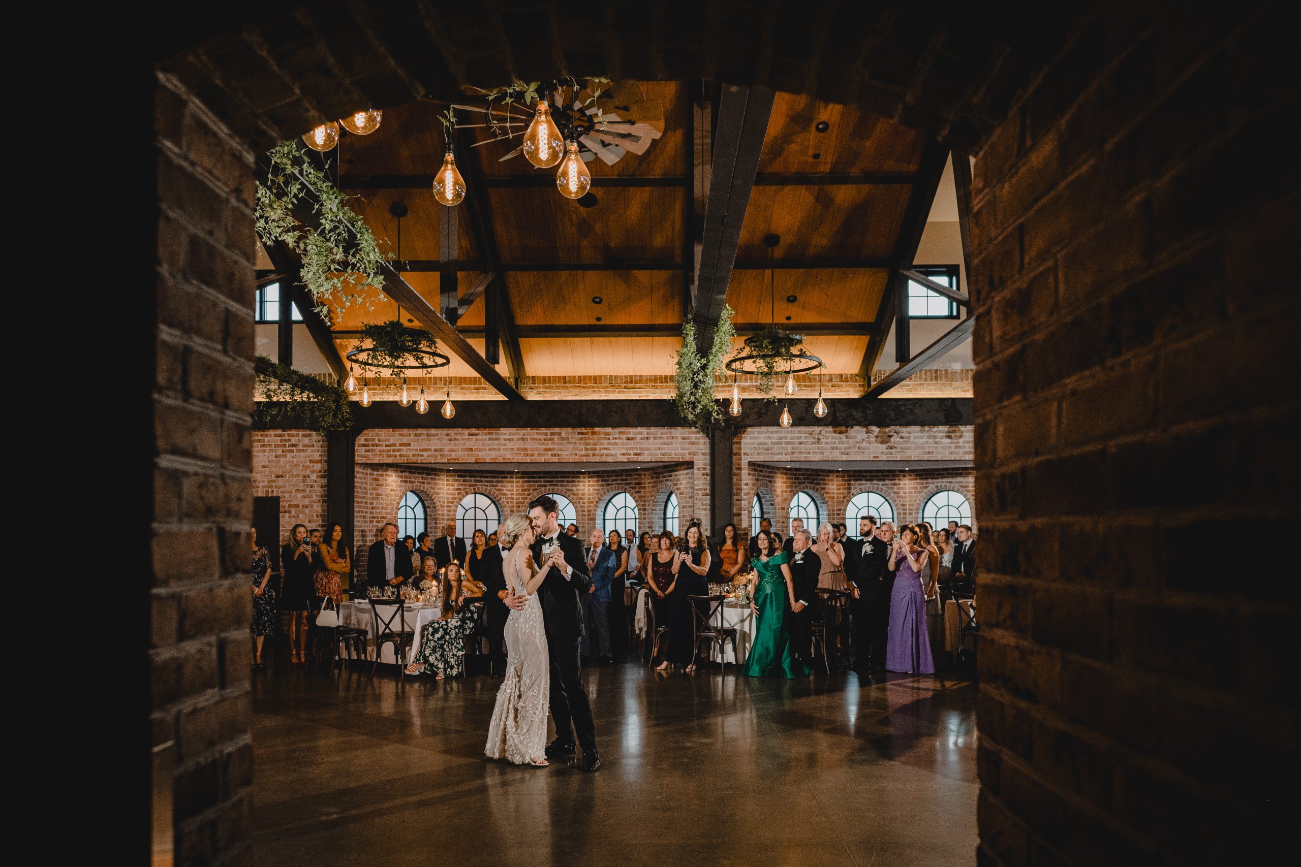 groom holds bride close to him during first dance at the Perona Farms Refinery