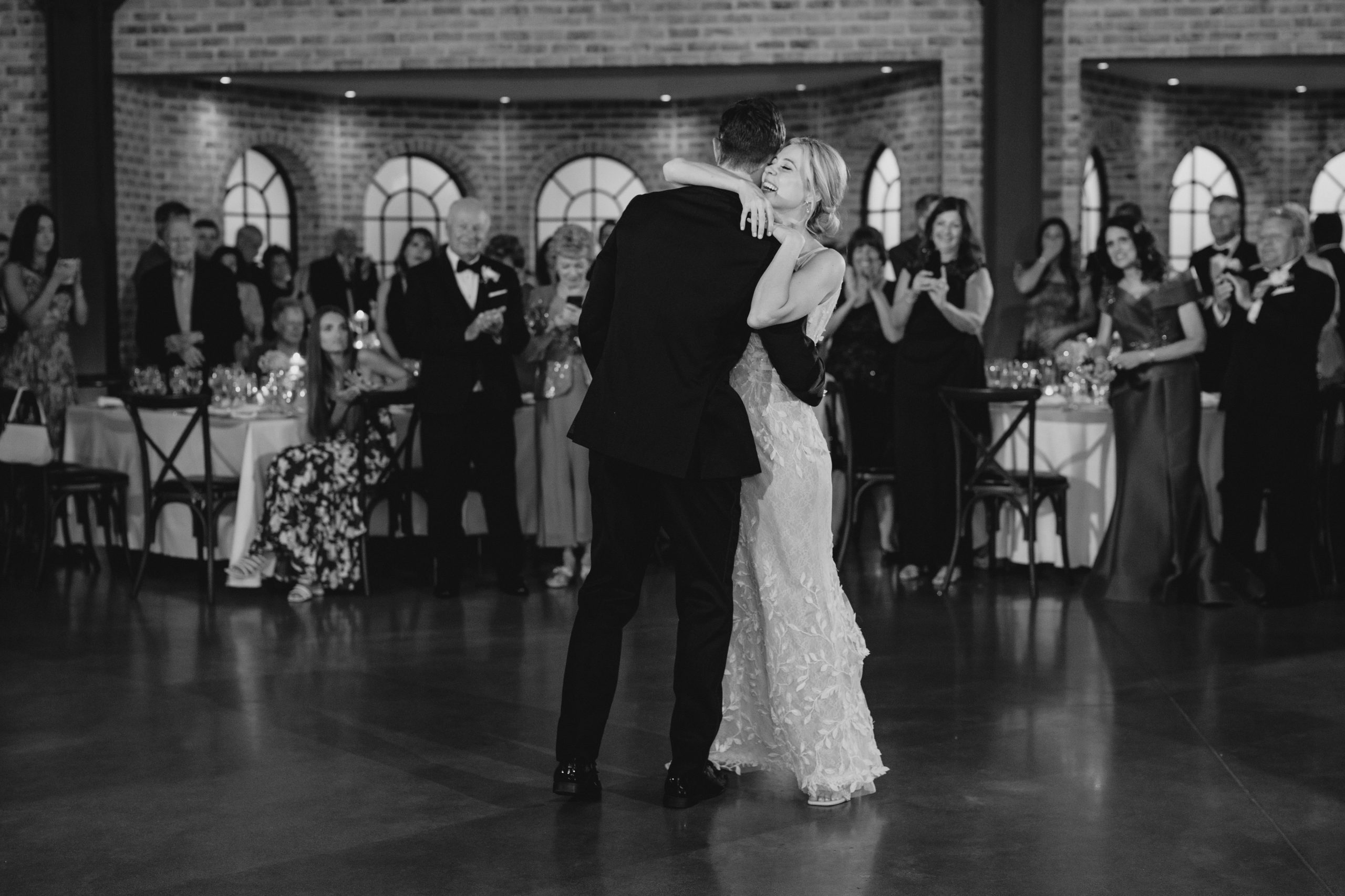 bride hugs groom around the neck after first dance in Andover NJ 
