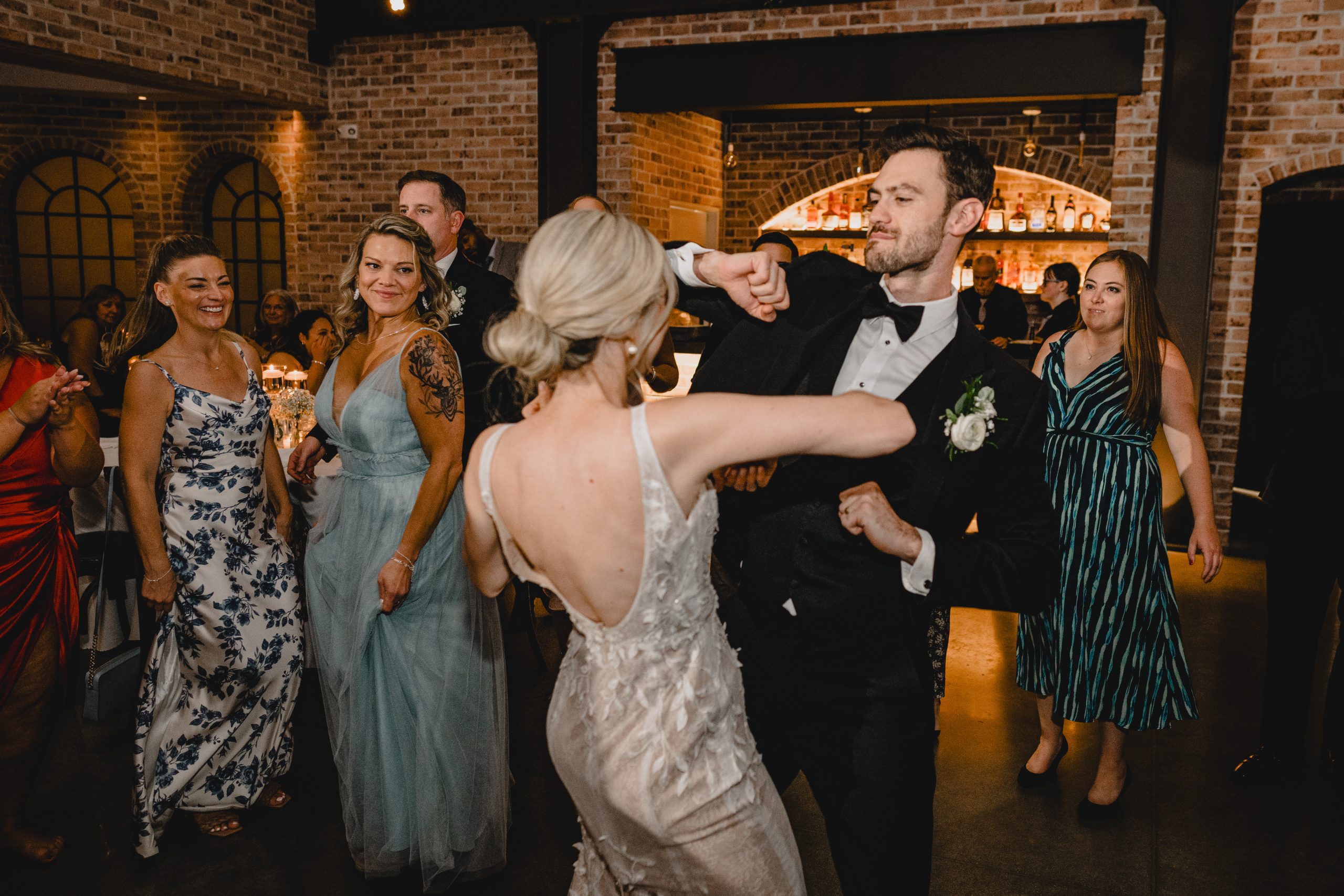 newlyweds dance during Andover NJ while wedding guests look on