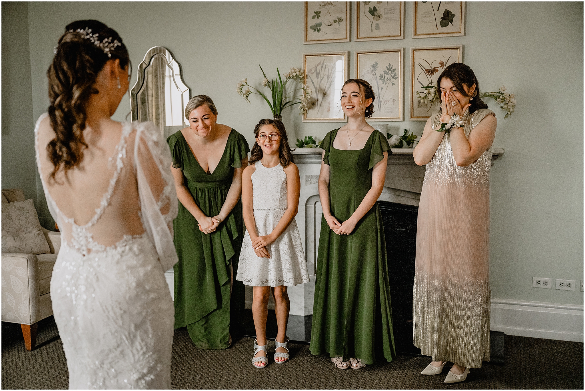 bridesmaids and flower girl have first look with bride in hotel room during prep for wedding day