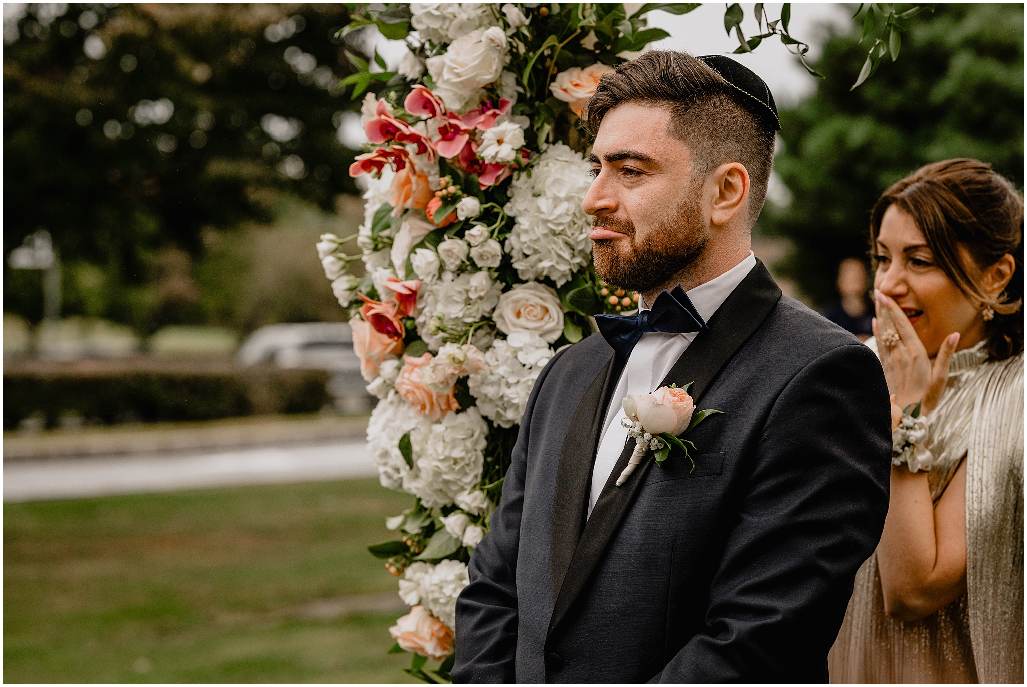 groom cries standing under chuppah waiting for bride