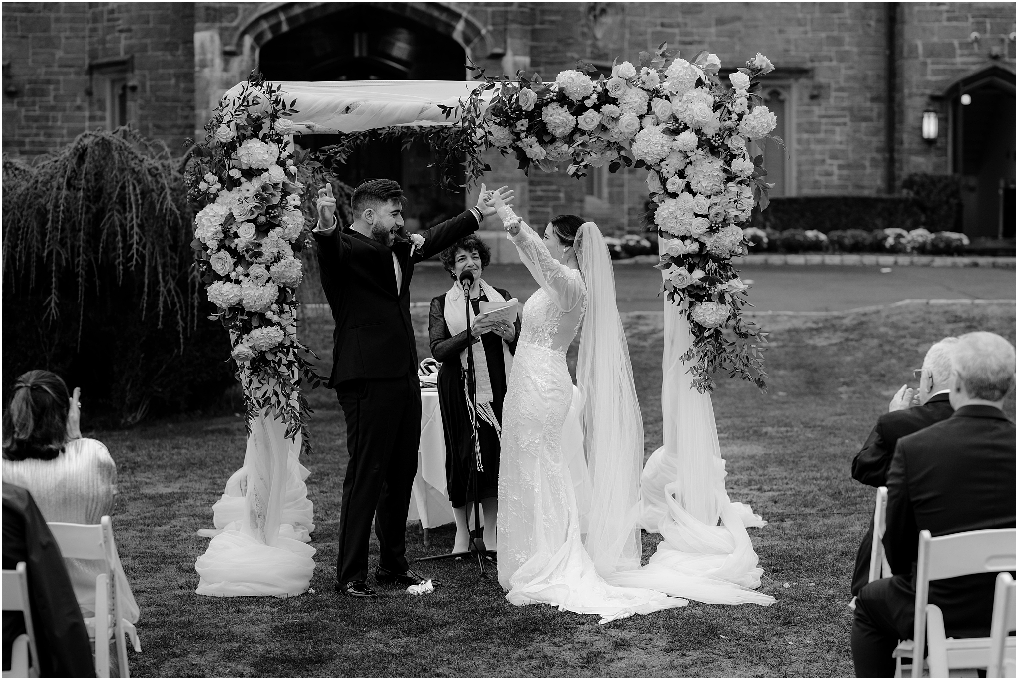 bride and groom standing in front of chuppah during wedding ceremony 