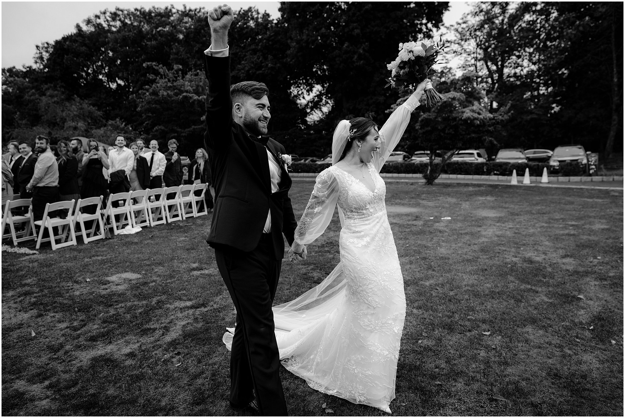 newlyweds cheer leaving wedding ceremony on lawn at Whitby Castle