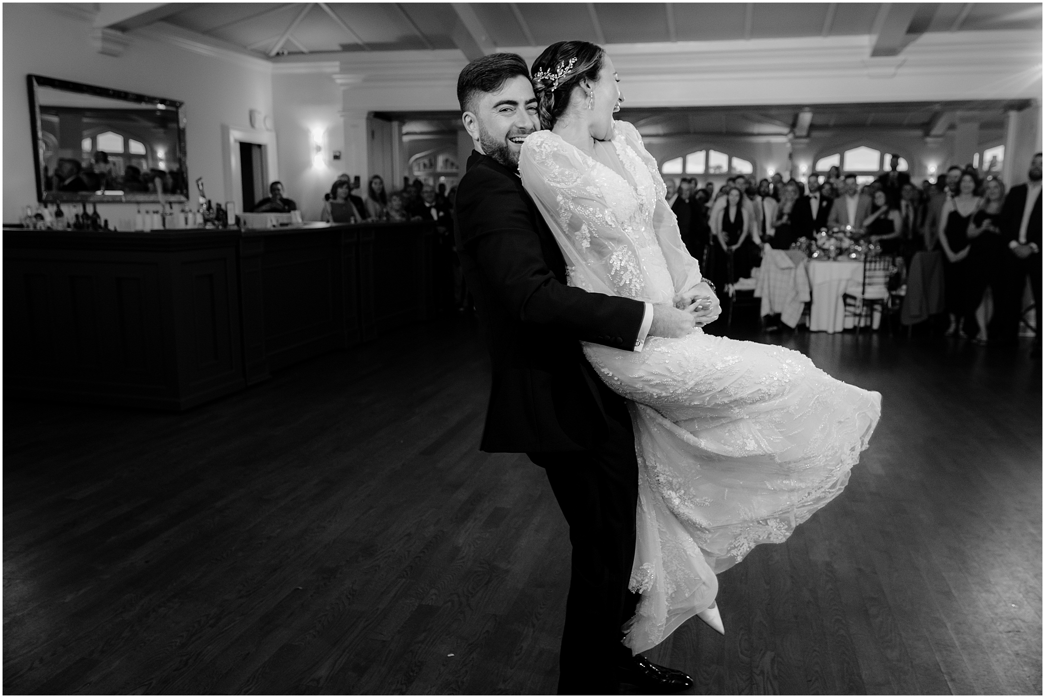 grooms picks up bride twirling her on dance floor at Whitby Castle