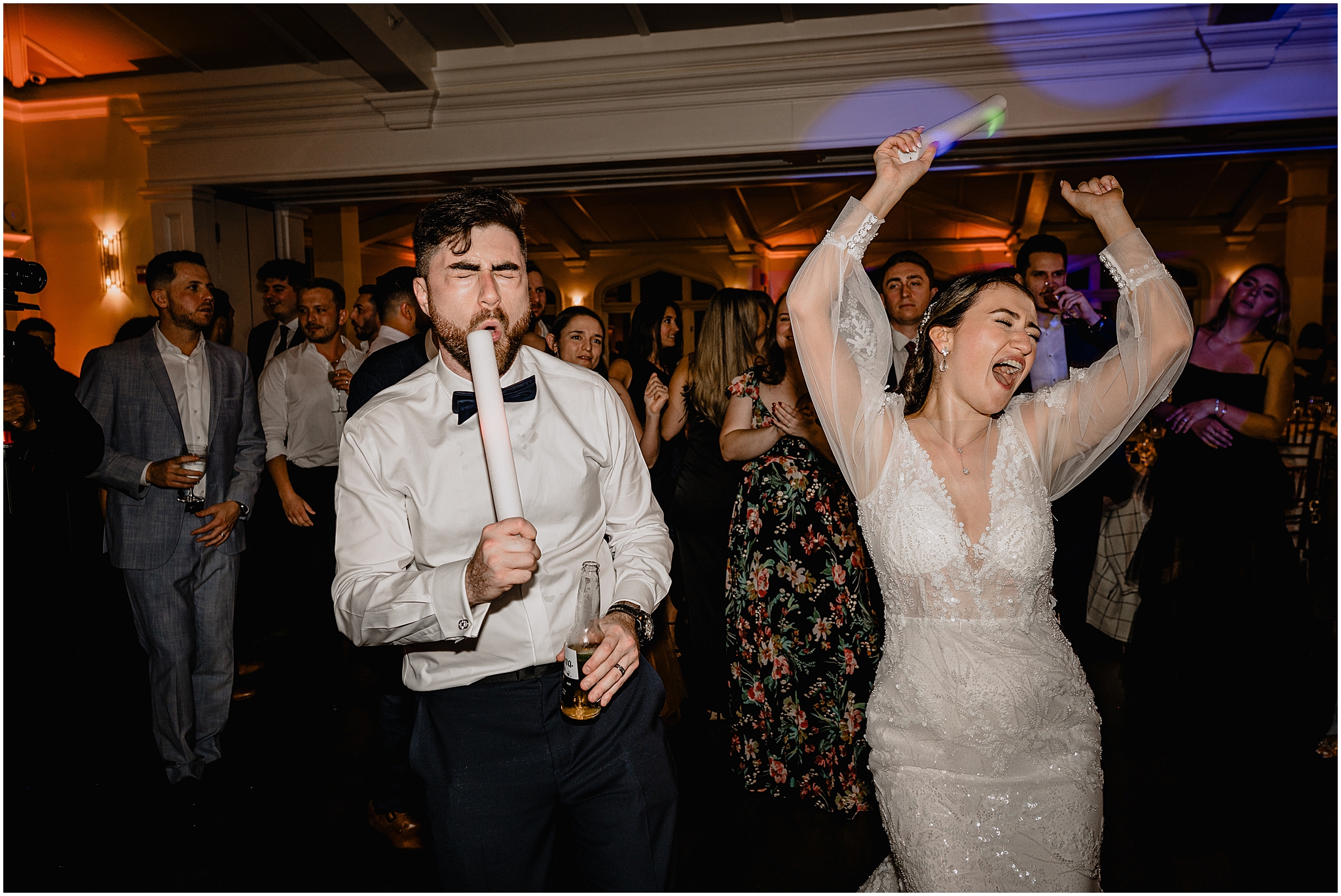 bride and groom dance during reception with glow sticks at Whitby Castle