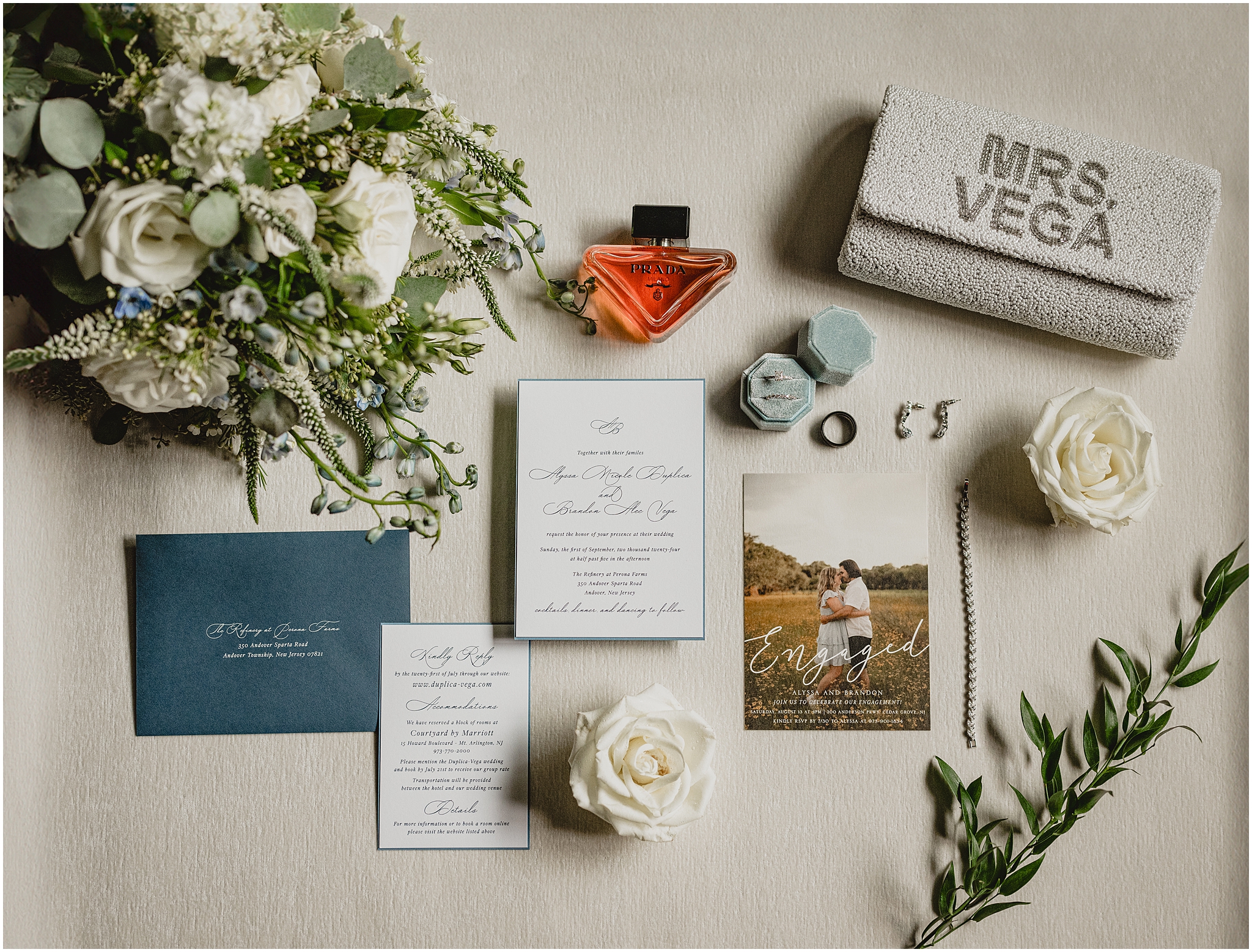navy and white invitation suite with bride's white and green bouquet for summer wedding at the Refinery at Perona Farms