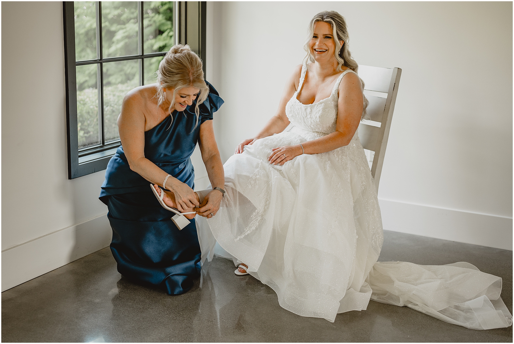 mother kneels to help bride with white chunky shoes