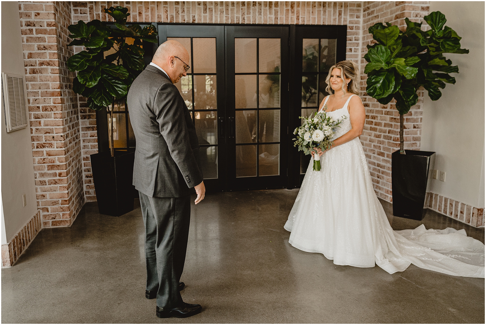 bride and dad have emotional first look in lobby at the Refinery at Perona Farms