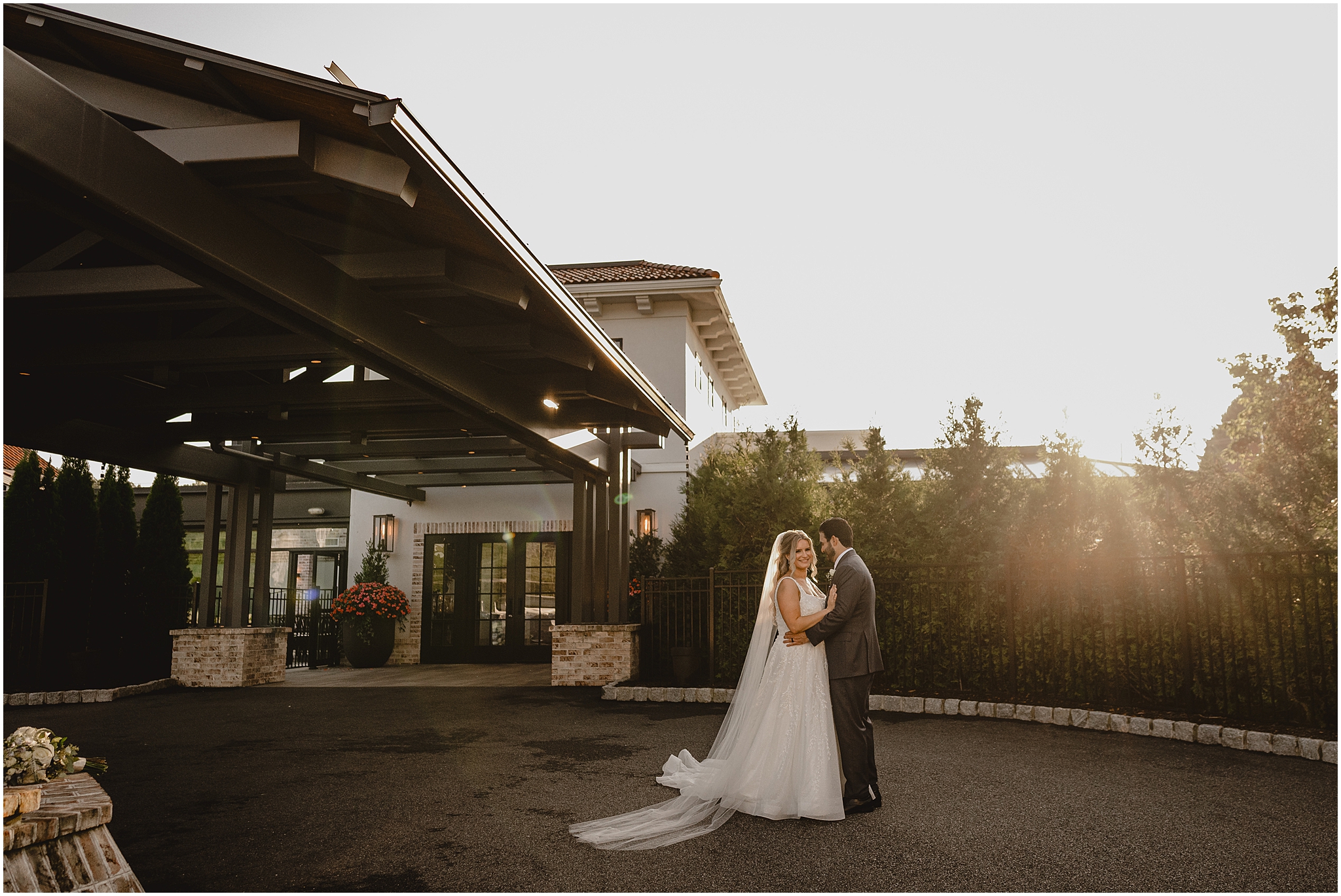 bride and groom hug by the awning at the Refinery at Perona Farms