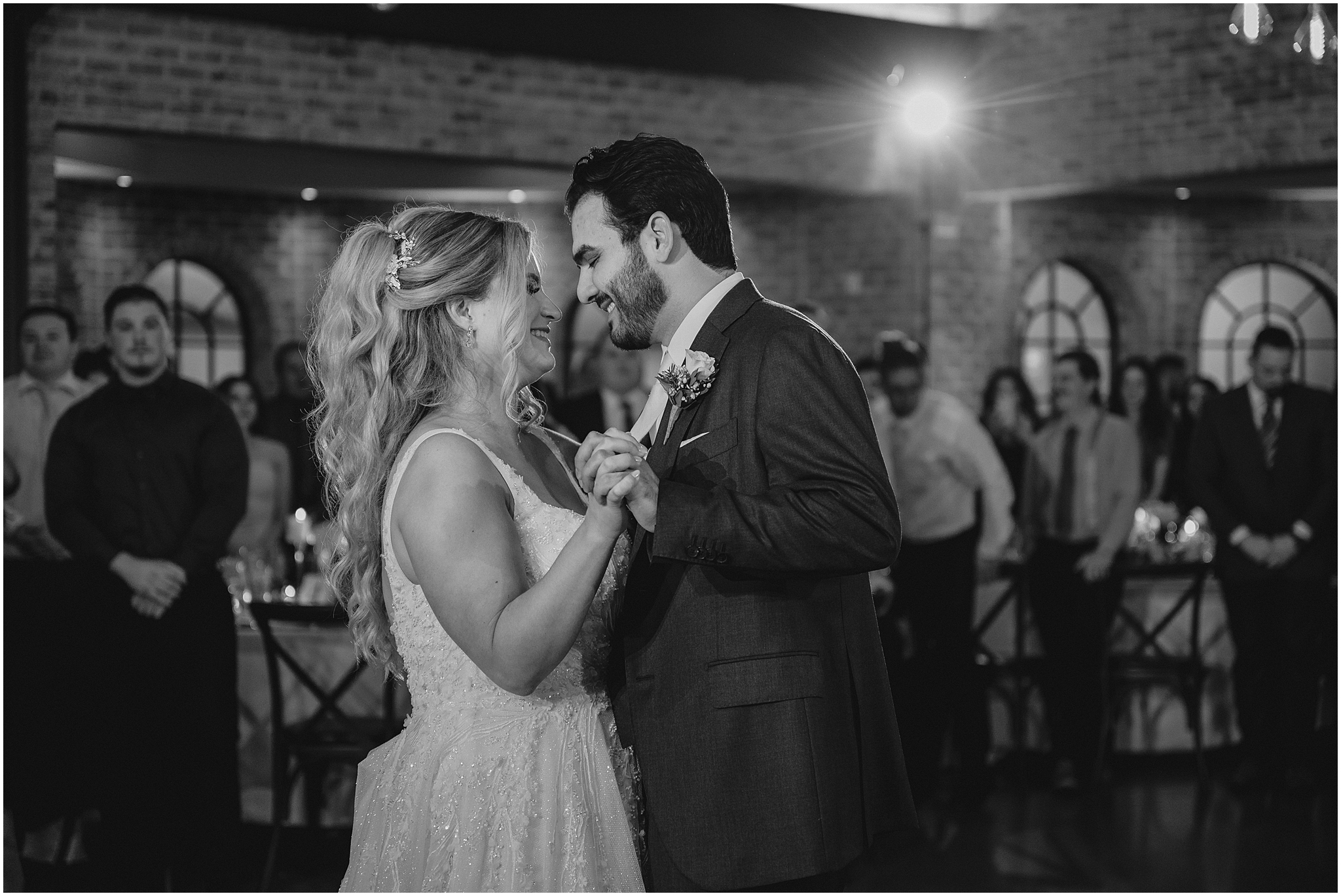bride and groom smile dancing together at reception in Andover NJ