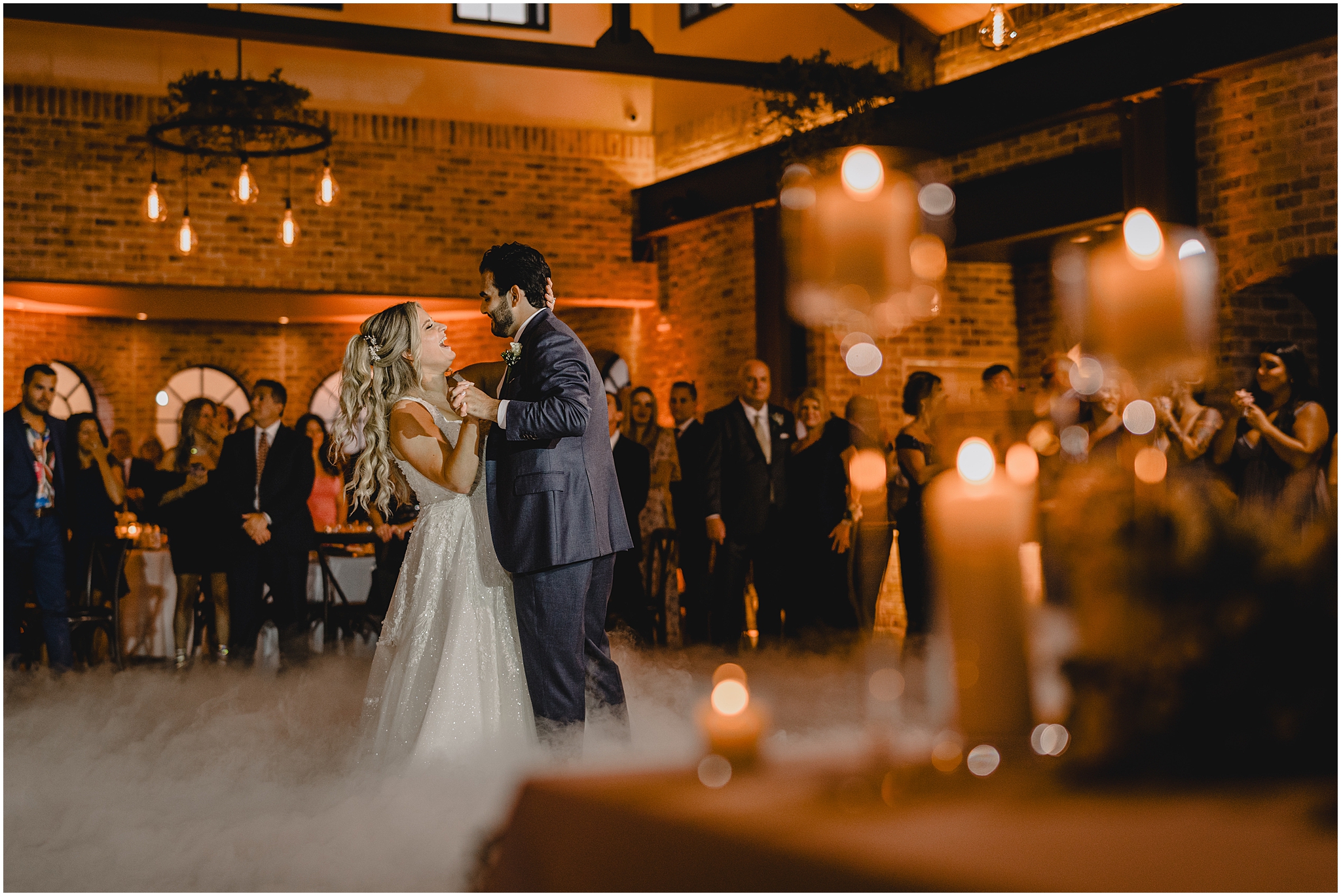 newlyweds dance at the Refinery at Perona Farms with fog around them