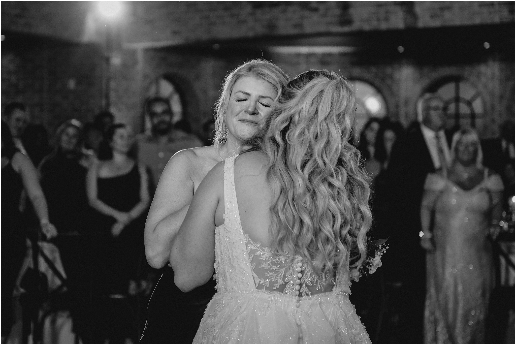 bride and mom dance together hugging during Andover NJ wedding reception 