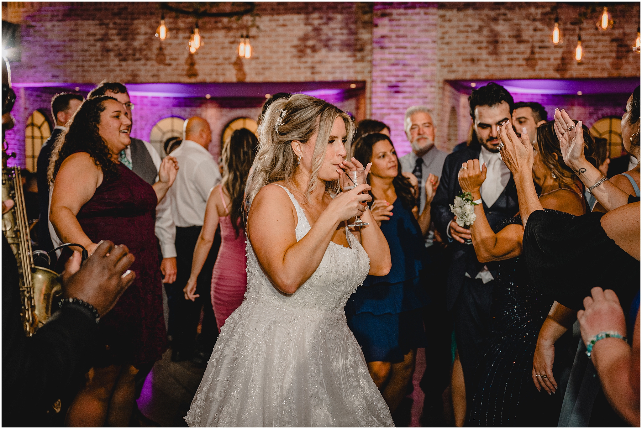 bride sips drink on dance floor during Andover NJ wedding reception 