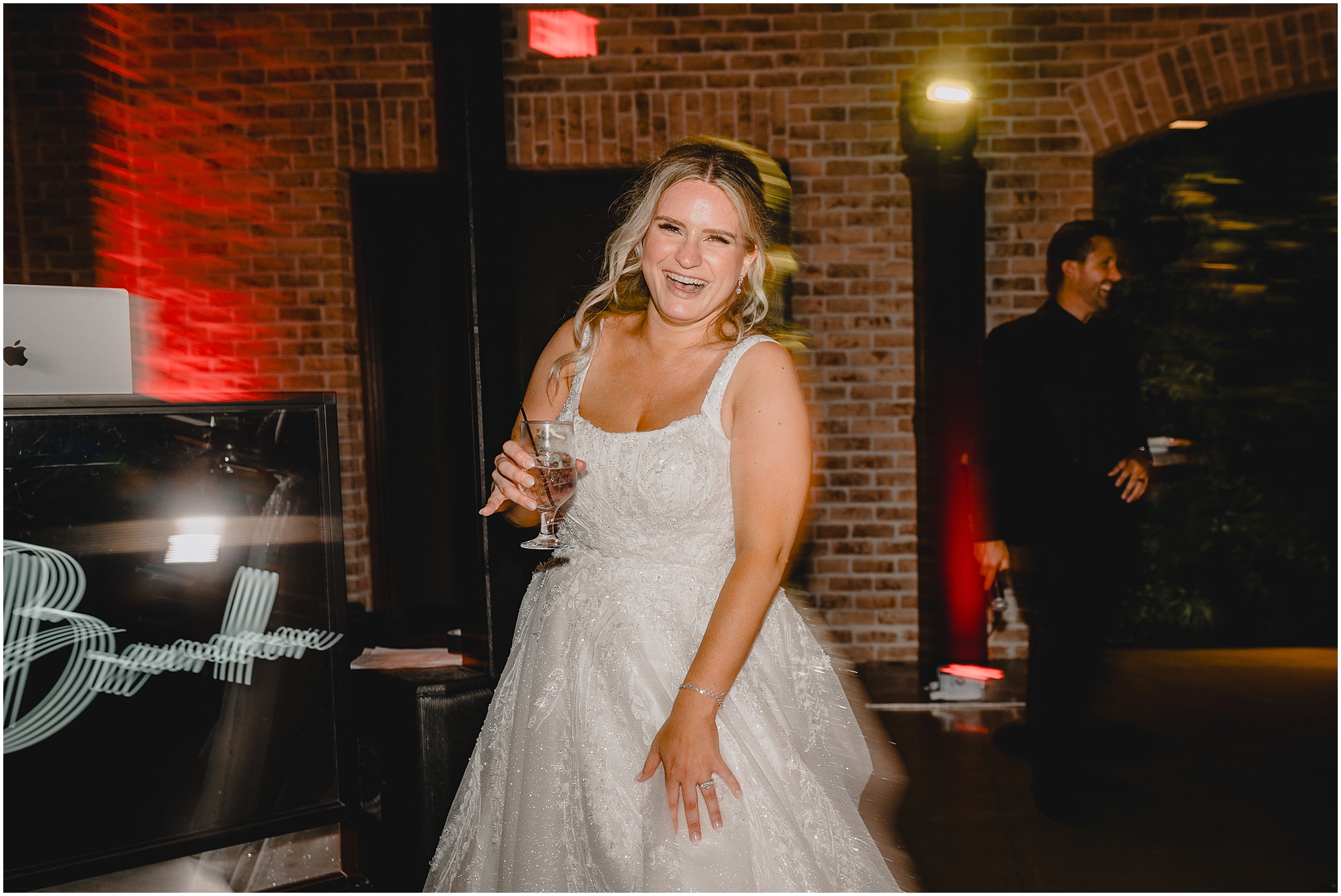 blurred photo of bride dancing during Andover NJ wedding reception with drink