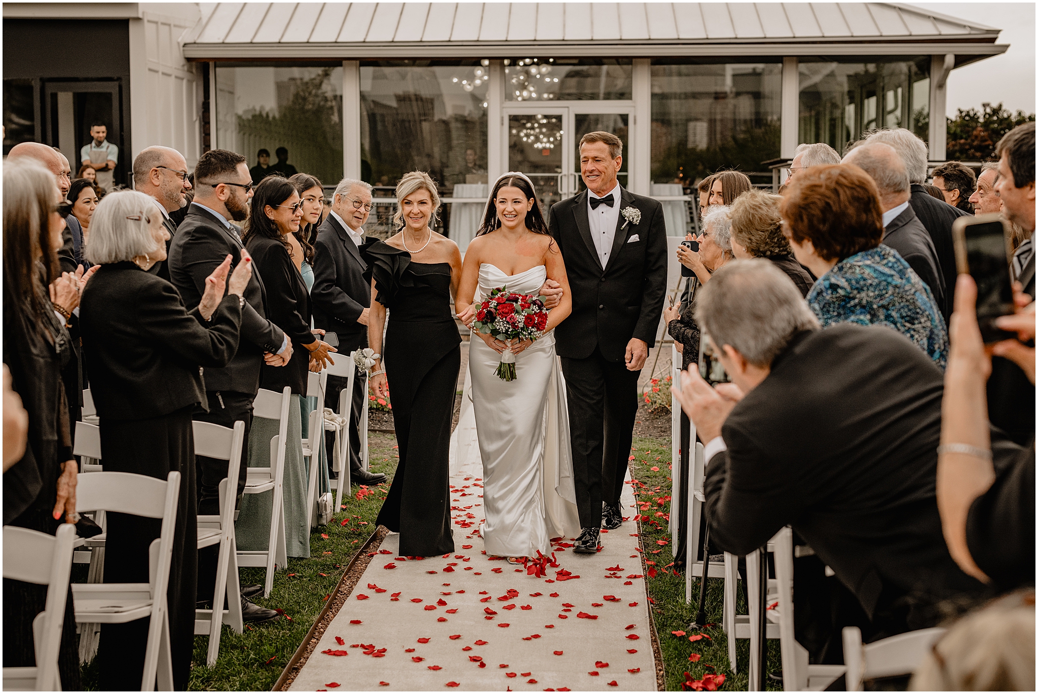 parents walk down the aisle with bride at the Liberty House