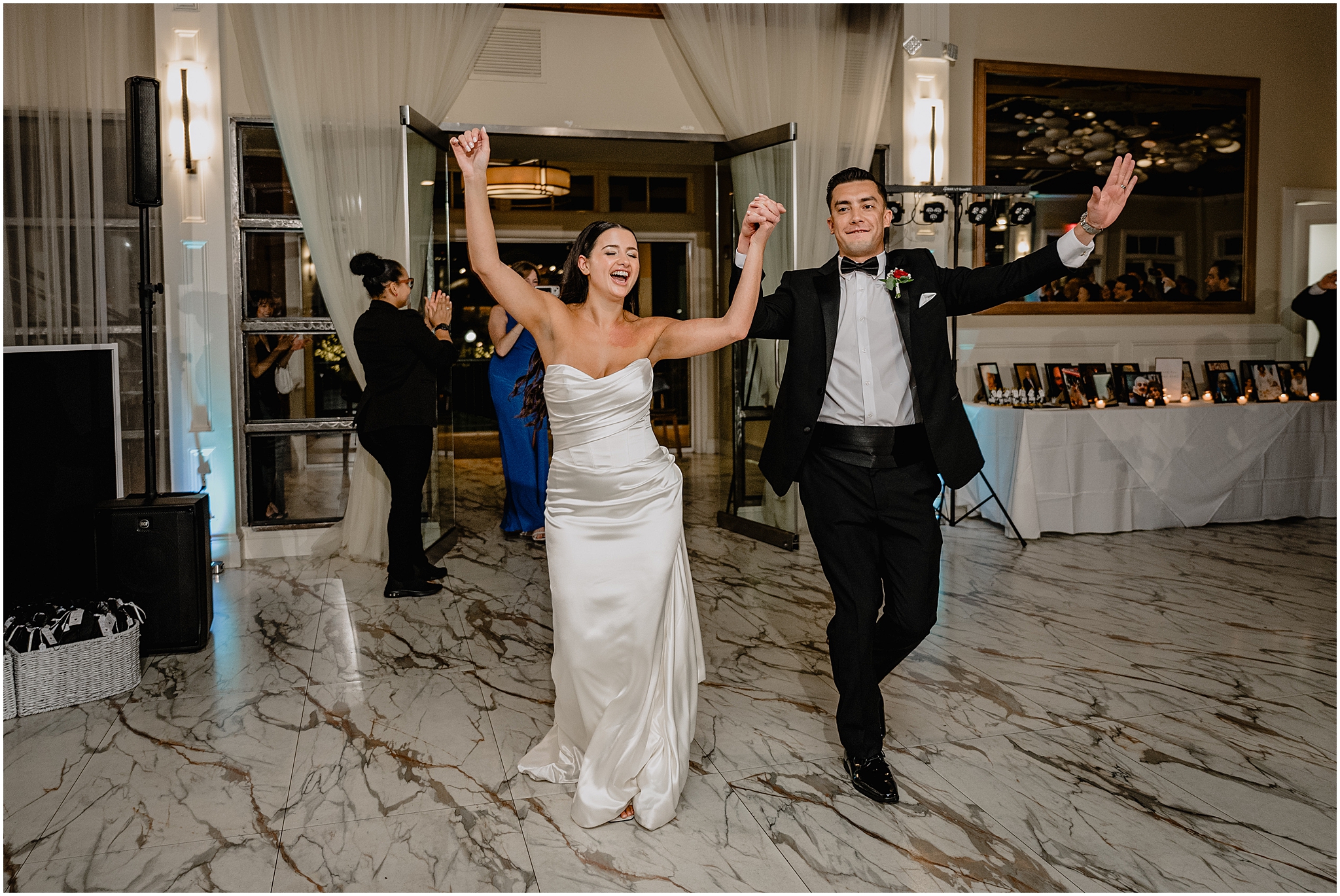 bride and groom cheer walking into ballroom during Jersey City wedding reception