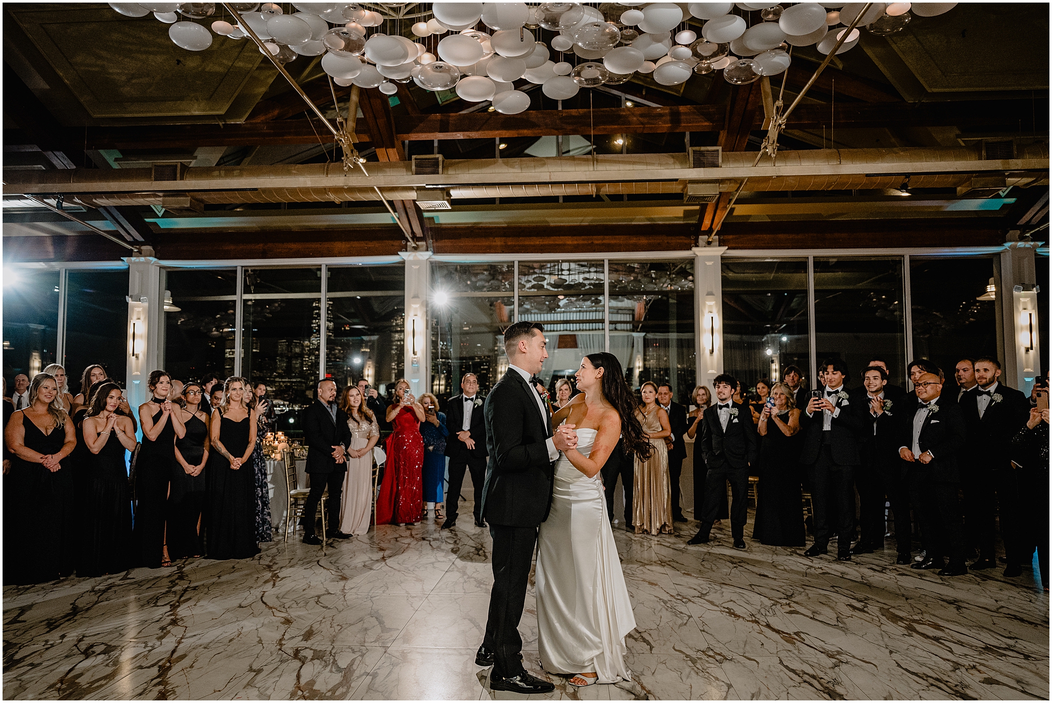 newlyweds dance under light installation during Jersey City wedding reception