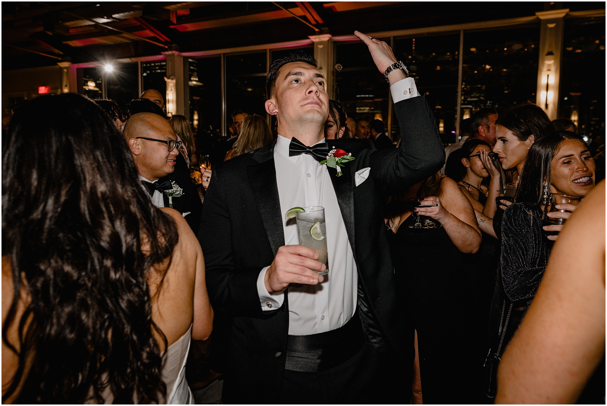 groom dances with hand in the air during Jersey City wedding reception