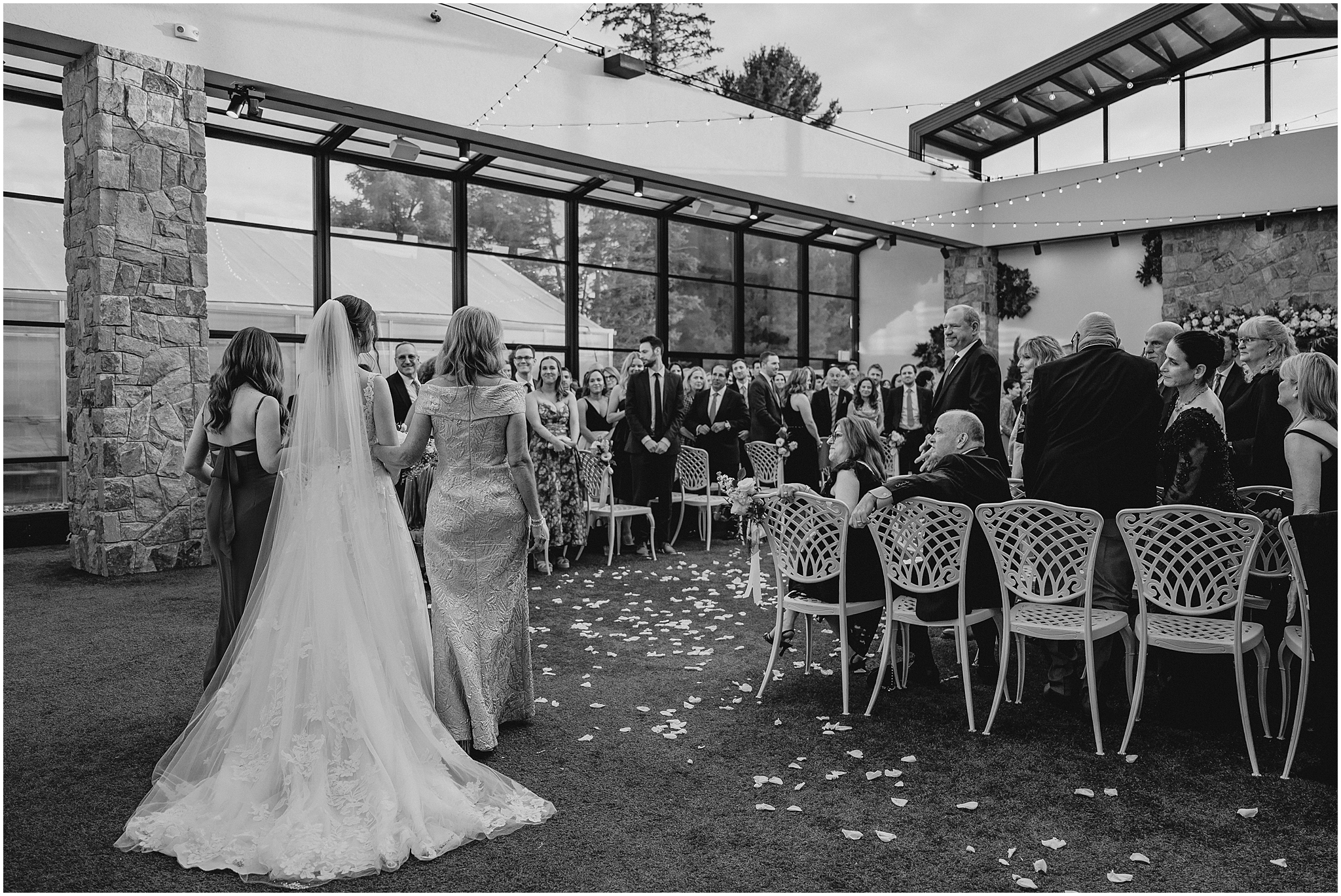 mother and sister escort bride down the aisle for wedding ceremony at the Reserve at Perona Farms