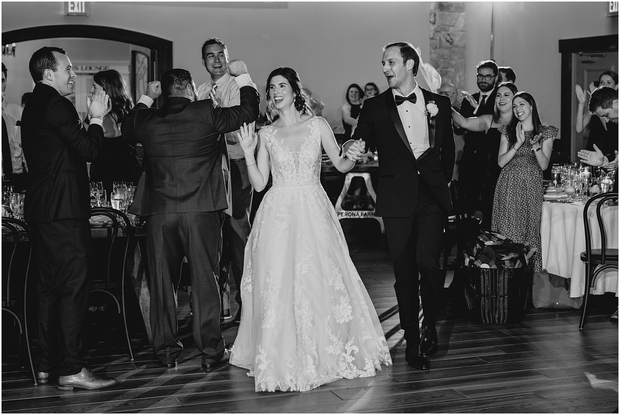 newlyweds cheer walking onto dance floor at wedding reception at Perona Farms