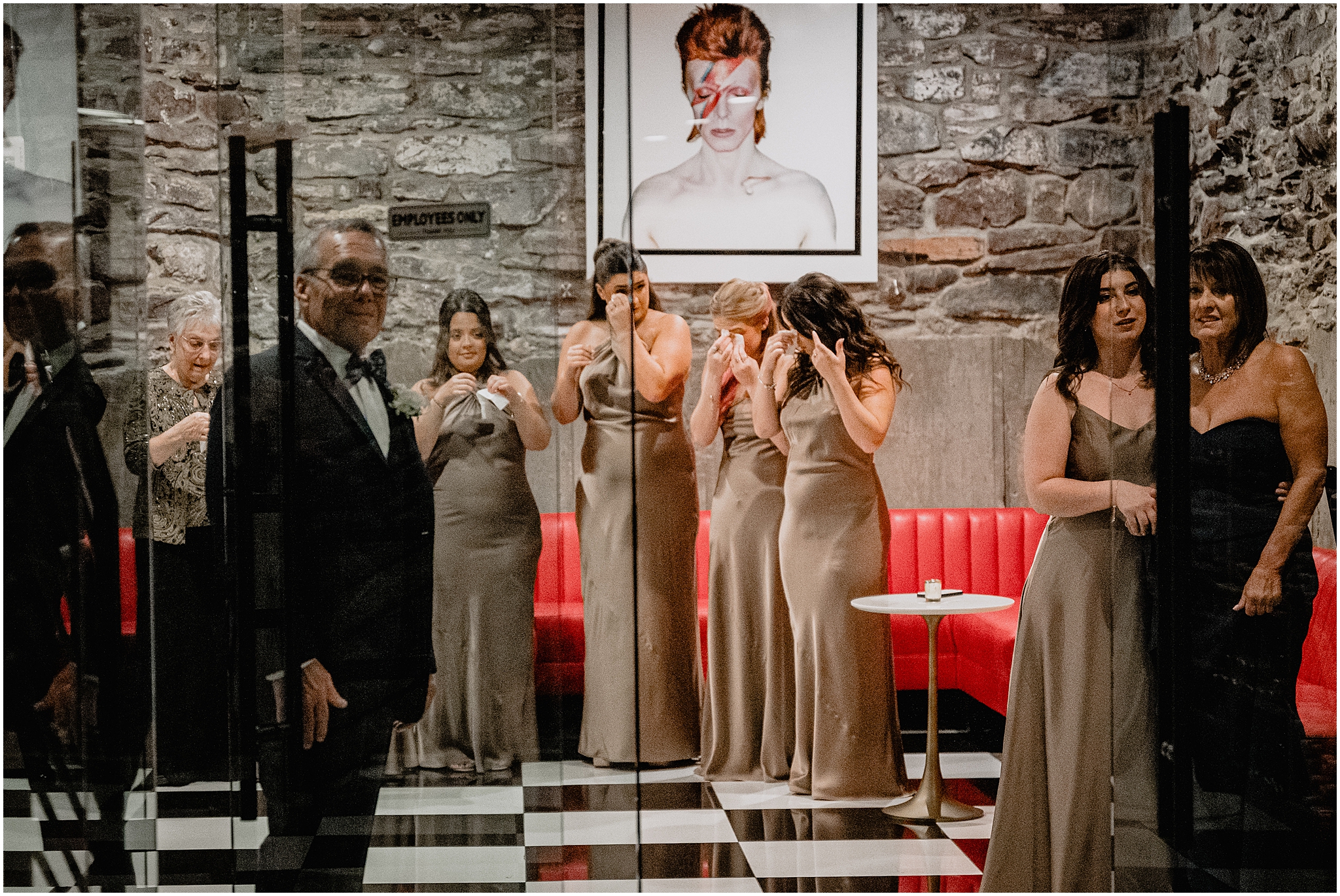 family and bridal party cry watching first look in cellar of The Logan Inn