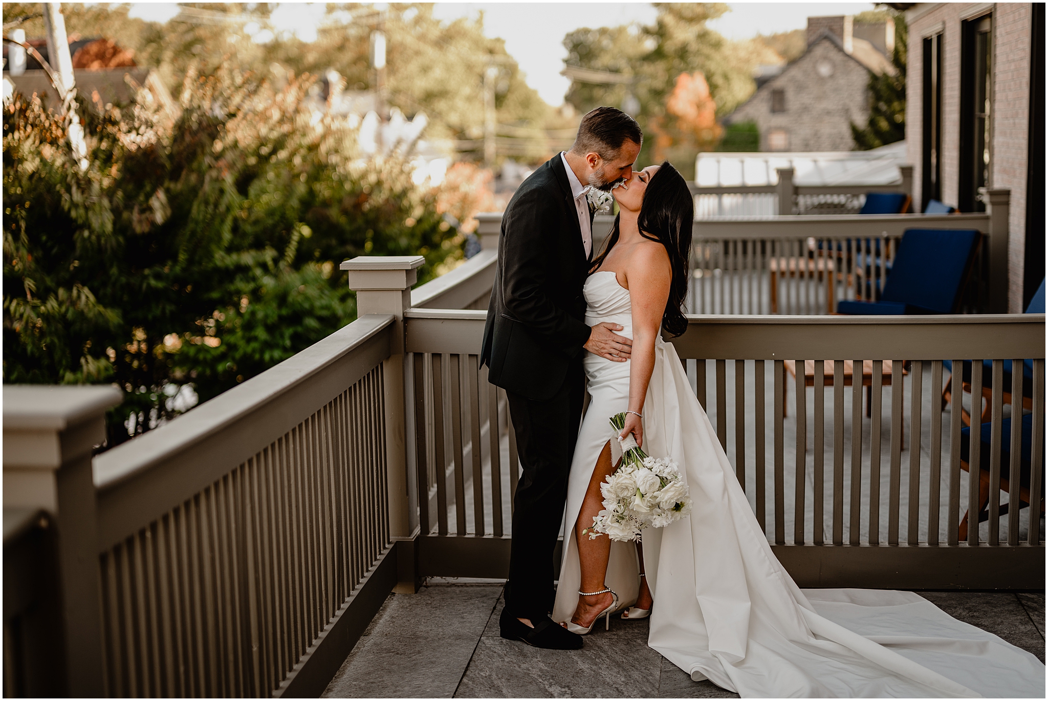 bride and groom kiss on balcony of The Logan Inn