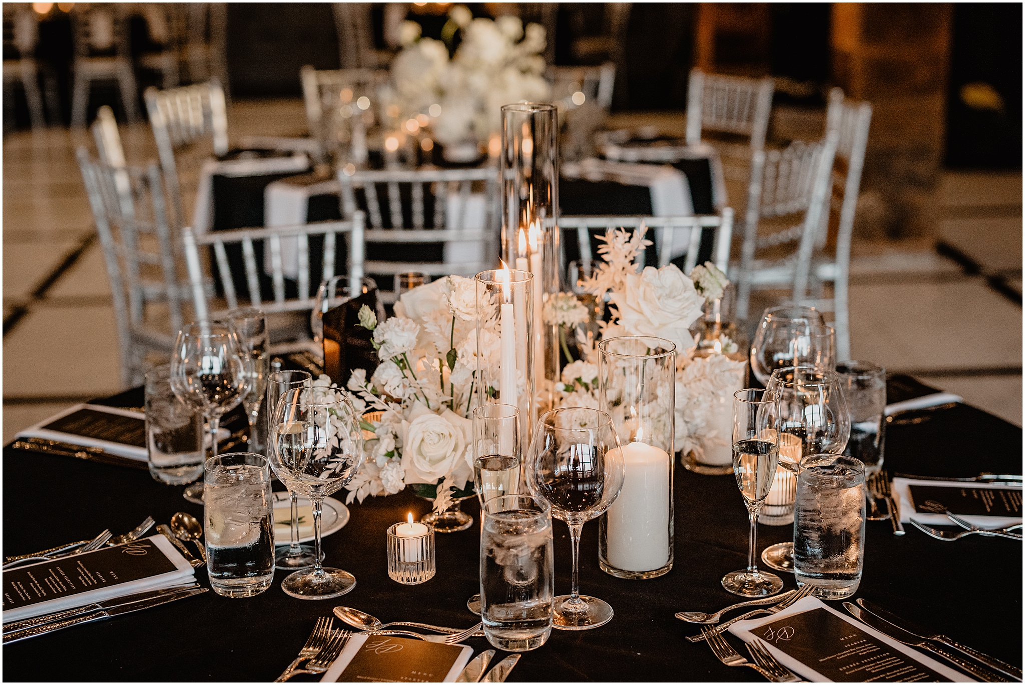 centerpiece with white roses and taper candles for elegant reception at The Logan Inn
