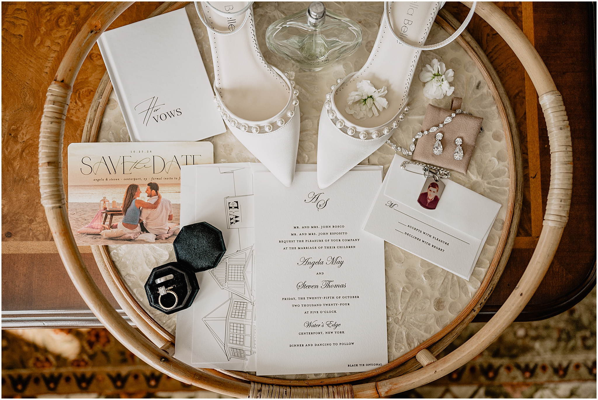 elegant Ivory shoes for the bride with wedding bands in dark green box rest on invitation suite 