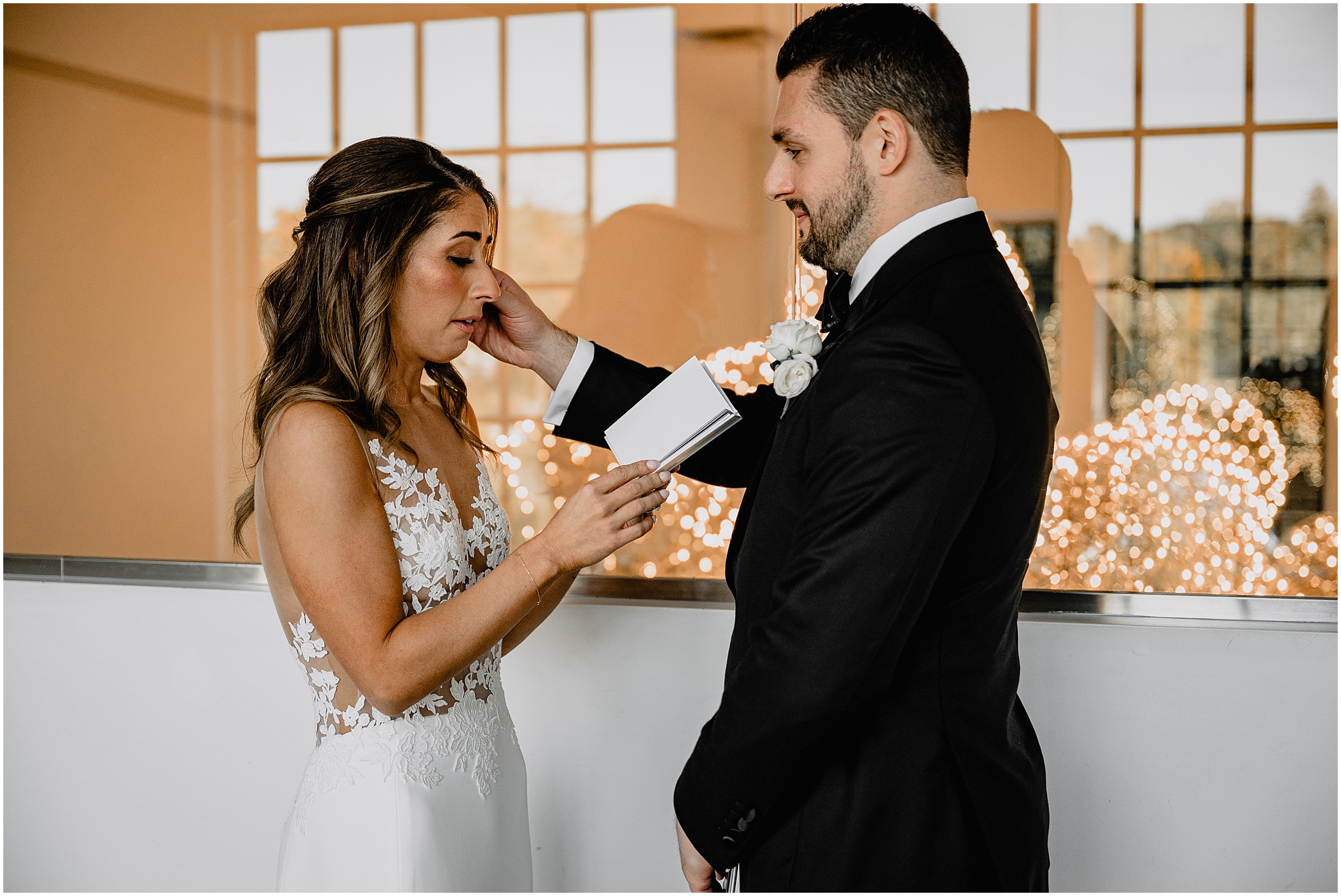 groom wipes tear off bride's face during private vow exchange on Long Island