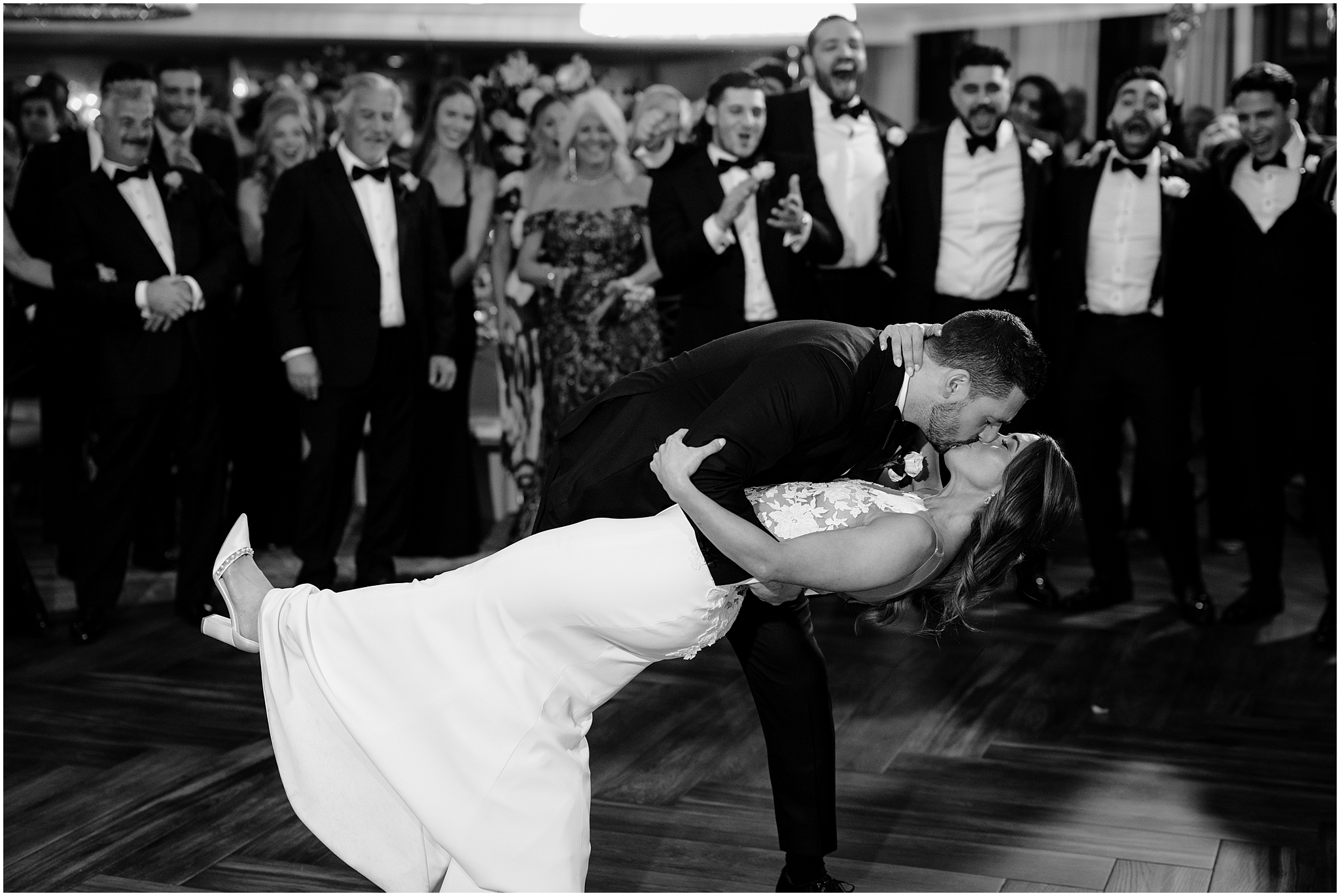 groom dips bride on dance floor at the Waters Edge at Centerport